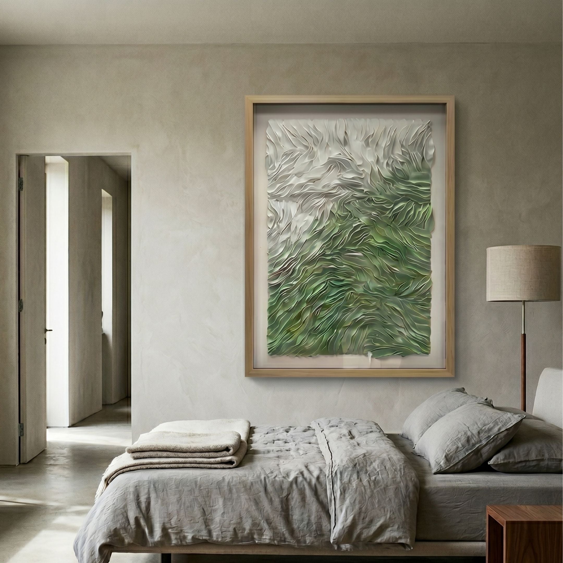 Florasca Green Ripple Leather 3D Framed Wall Art by Giant Sculptures displayed above a linen-dressed bed in a neutral bedroom with a floor lamp and open doorway.