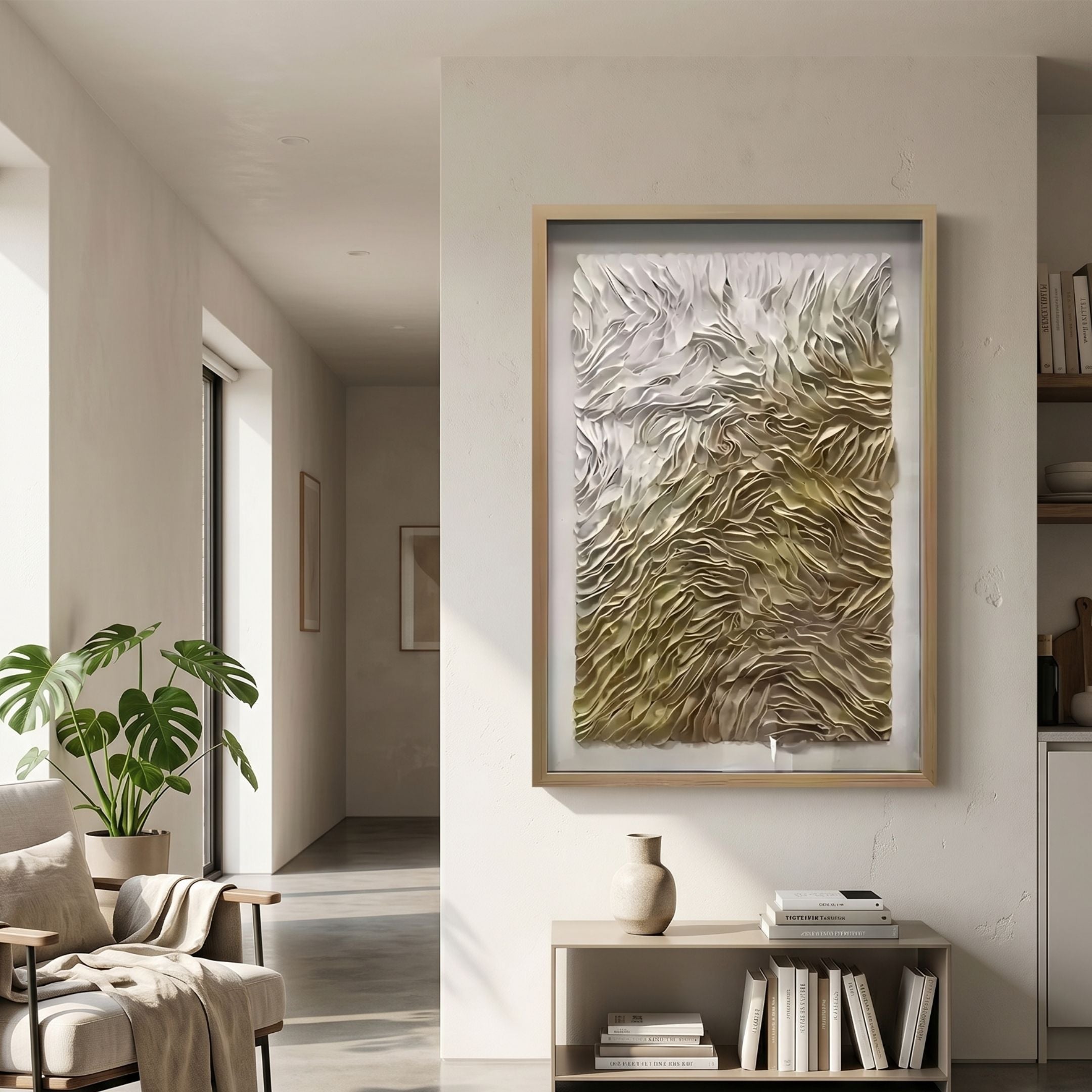 Florasca Gold Ripple Leather 3D Framed Wall Art by Giant Sculptures displayed in a neutral living room above a console with vase and books, beside a monstera plant.