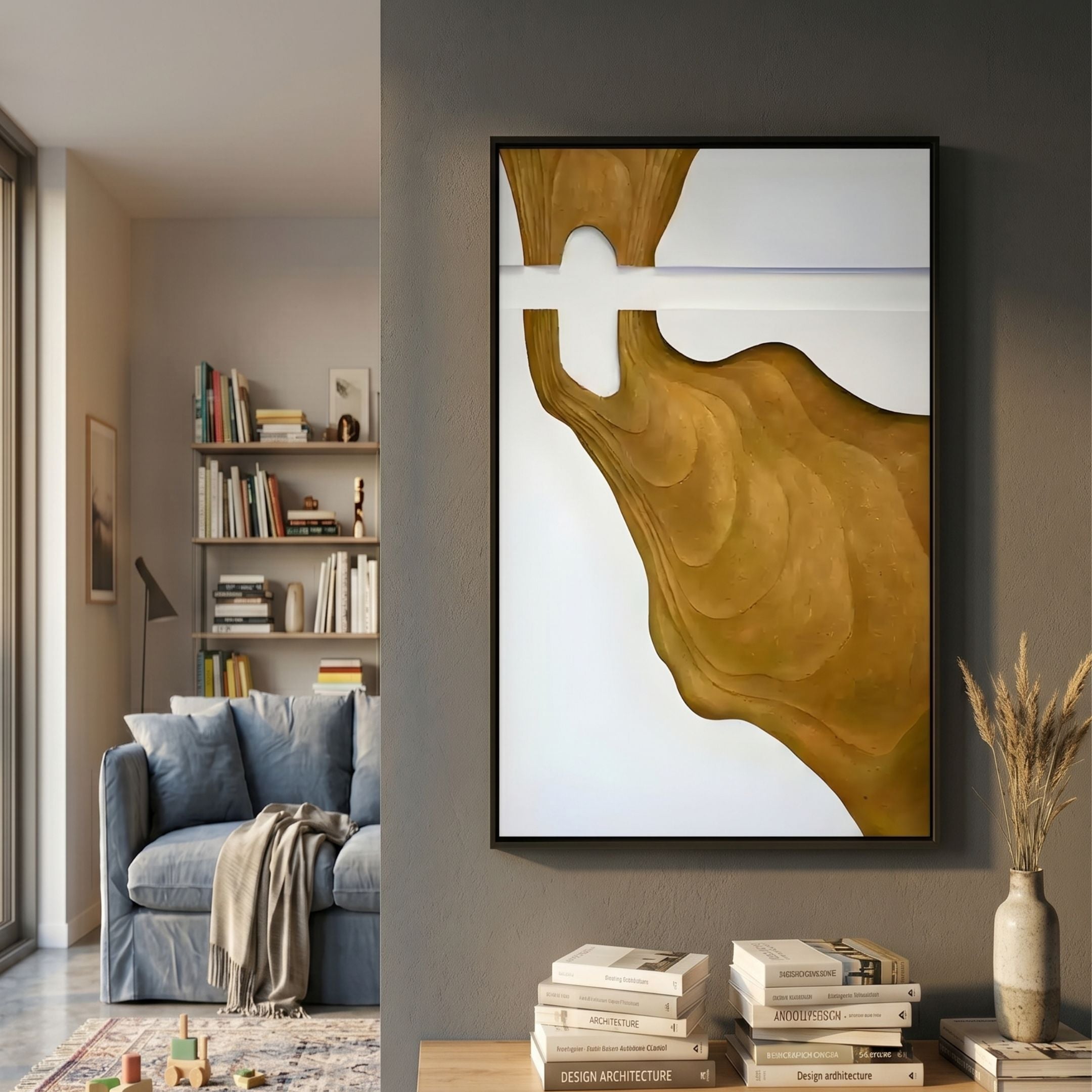 Fluvien Gold Flow 3D Carving Wall Art by Giant Sculptures displayed on a grey wall above a console with books in a living room beside a blue sofa and bookshelf.