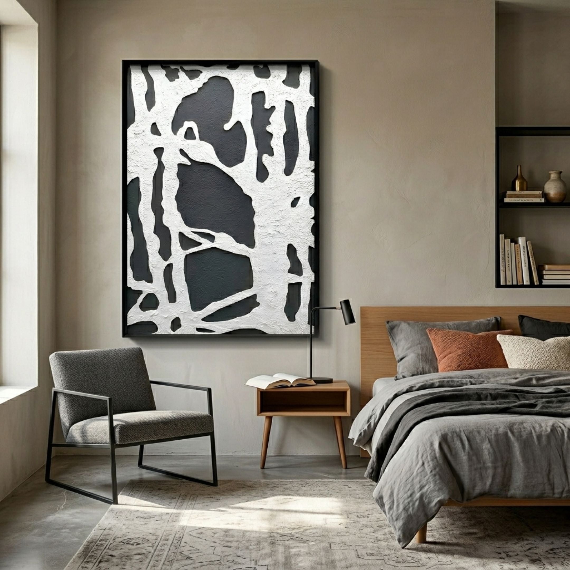 Drosan Midnight Trace I Wood Carving 3D Wall Art with white organic relief on black, framed above a nightstand beside a grey bed and armchair.