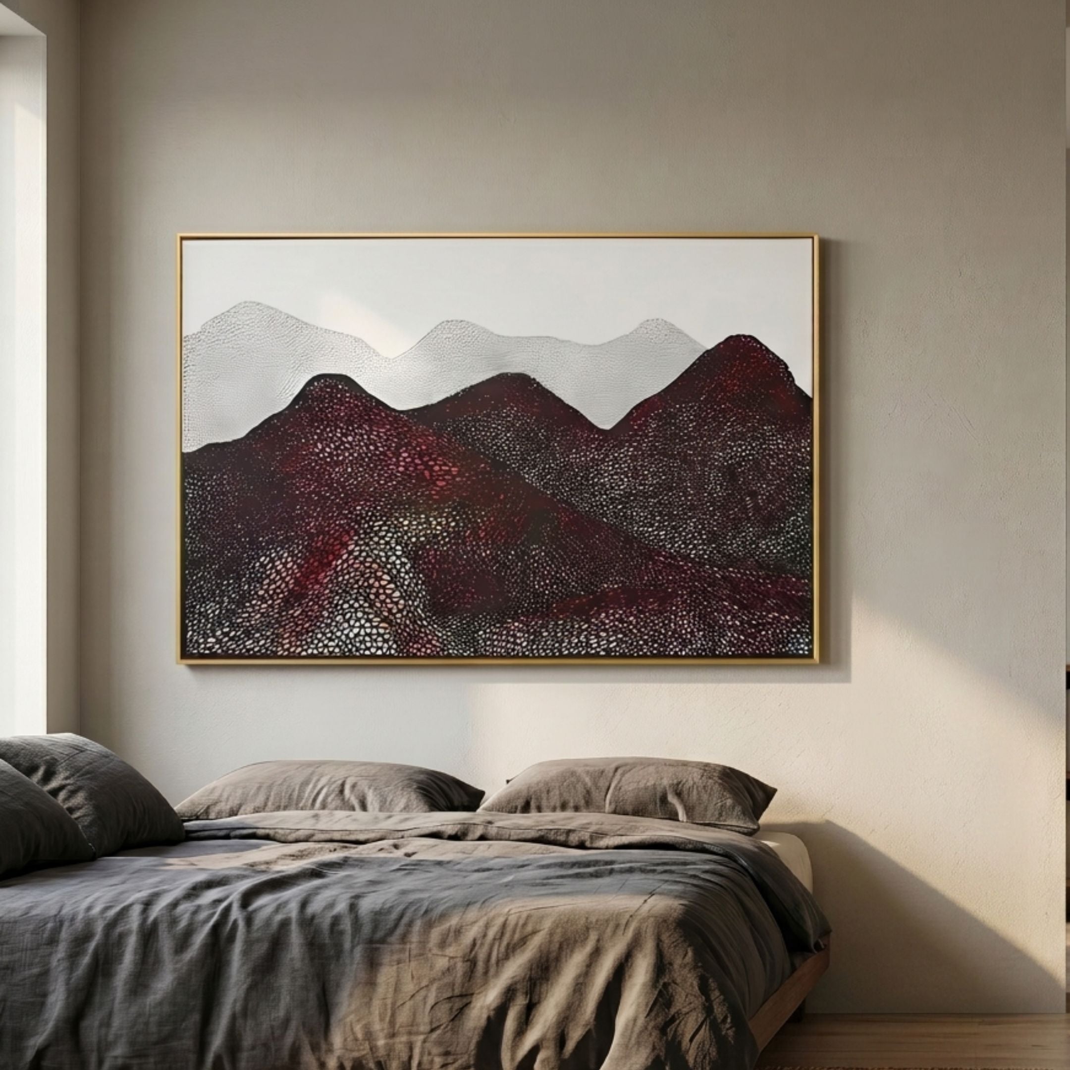 Caelora Sculpted Mesh Landscape 3D Wall Art in maroon, crimson and white with gold frame, mounted above a linen-dressed bed in a warm neutral bedroom.