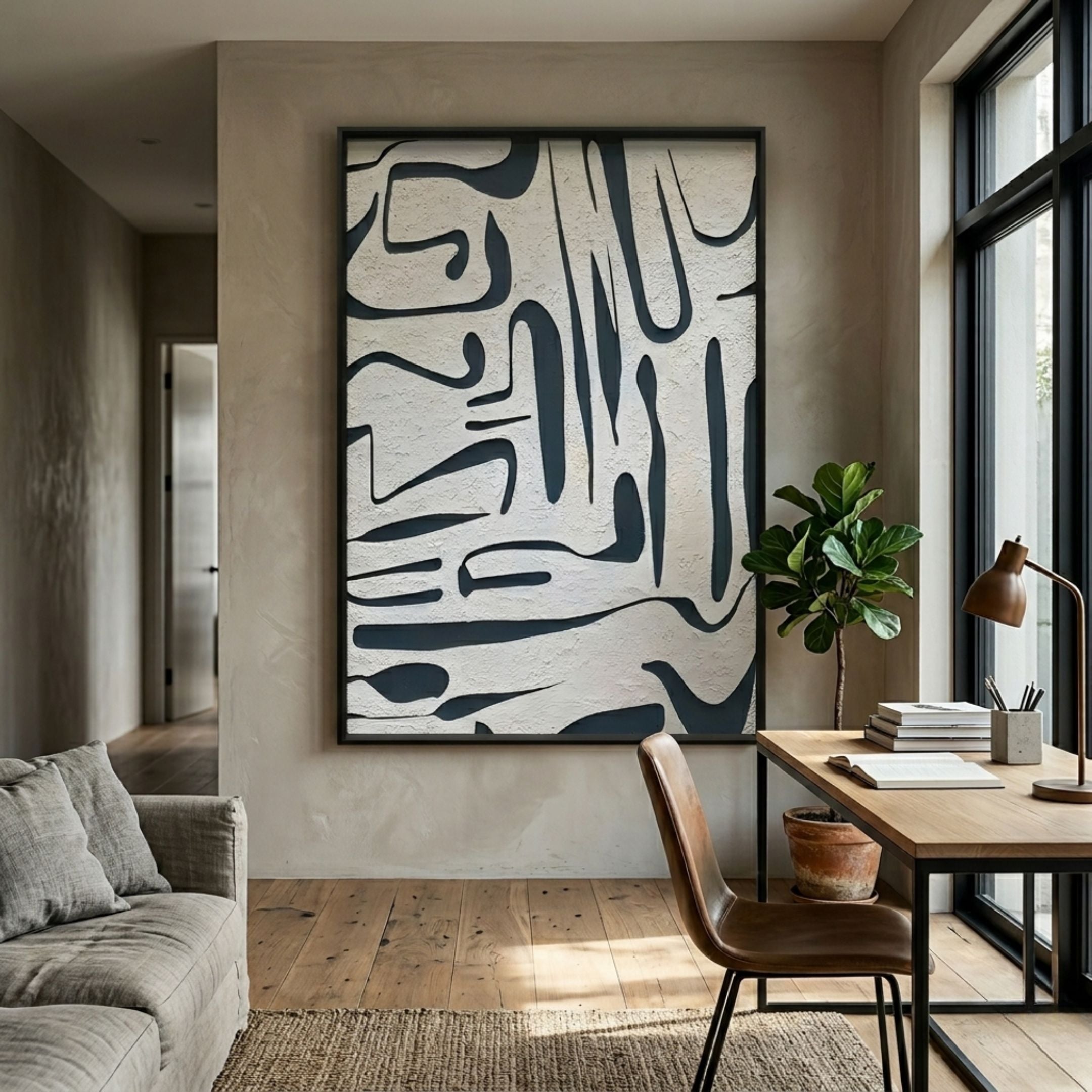Dunari Midnight Trace I Wood Carving 3D Wall Art with black abstract linework on a textured white ground, displayed above a wooden desk beside a fiddle leaf fig.