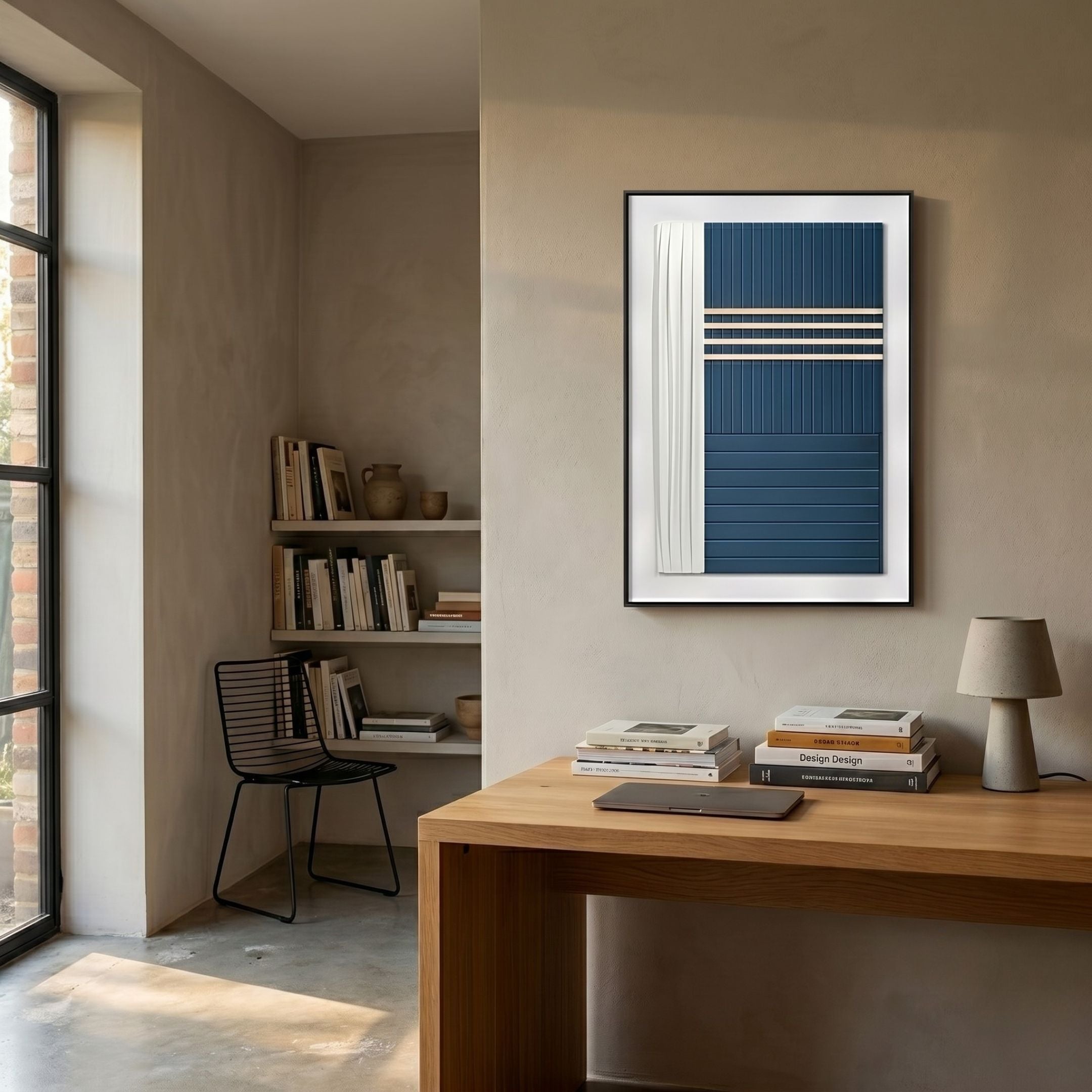 Trivaro Blue Panel III Wood Carving 3D Wall Art by Giant Sculptures, framed in black above a wooden desk in a beige study with bookshelves and chair.
