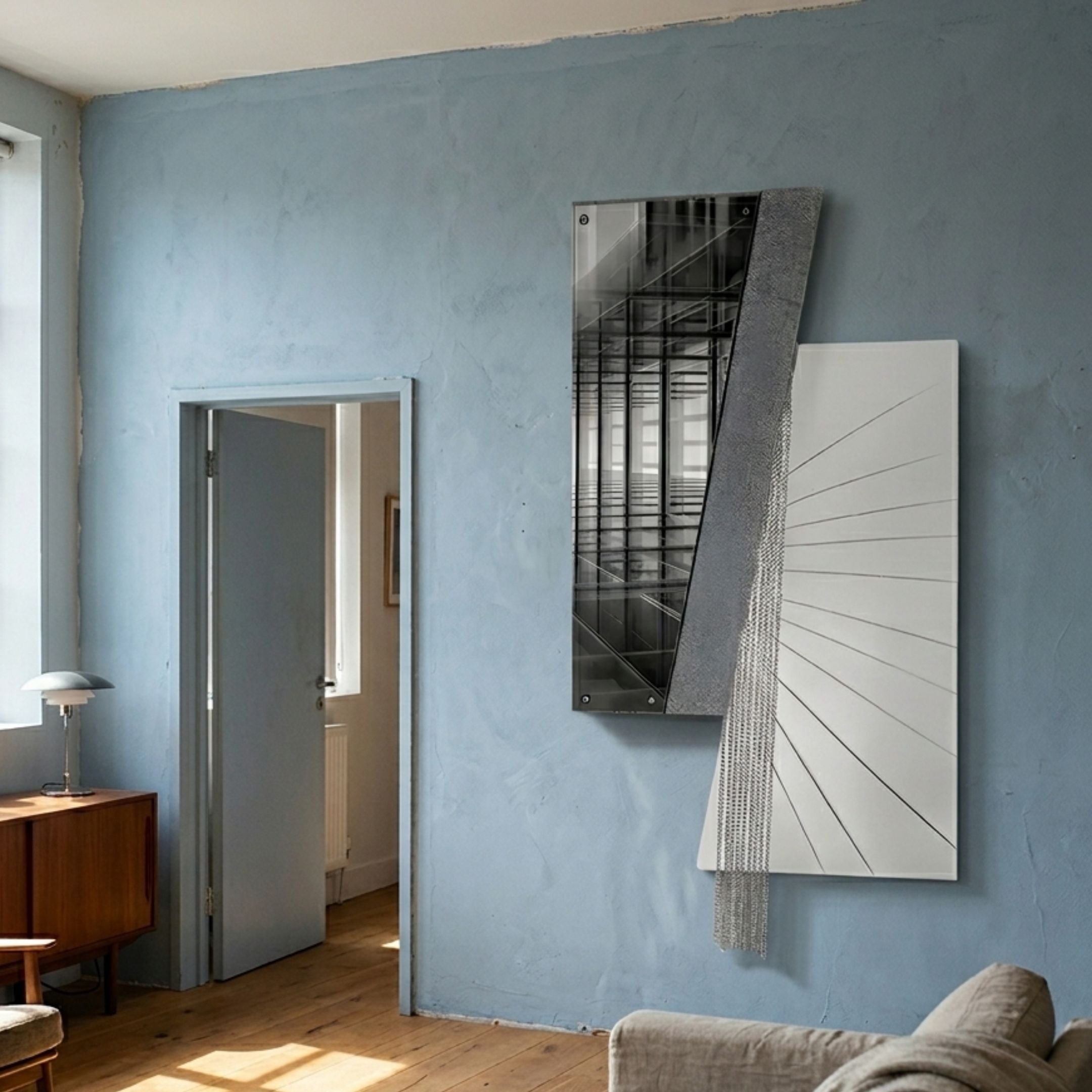 Urbis Black & White Gridview Chain Leather 3D Wall Art by Giant Sculptures displayed on a pale blue plaster wall in a living room beside an open doorway.