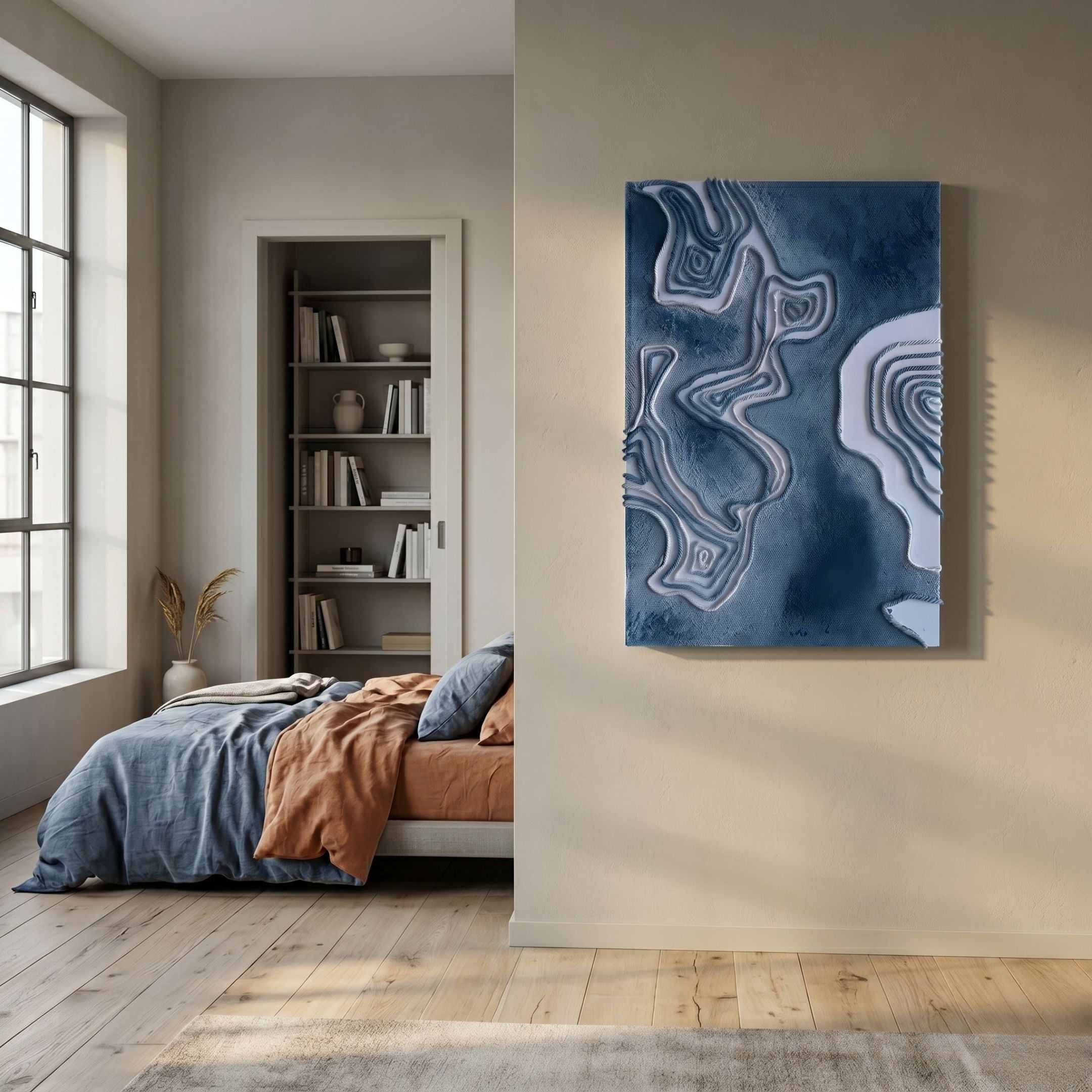 Terracore Midnight Blue Contour Relief Abstract 3D Wall Art displayed on a beige bedroom wall beside a bed with blue and terracotta linens.