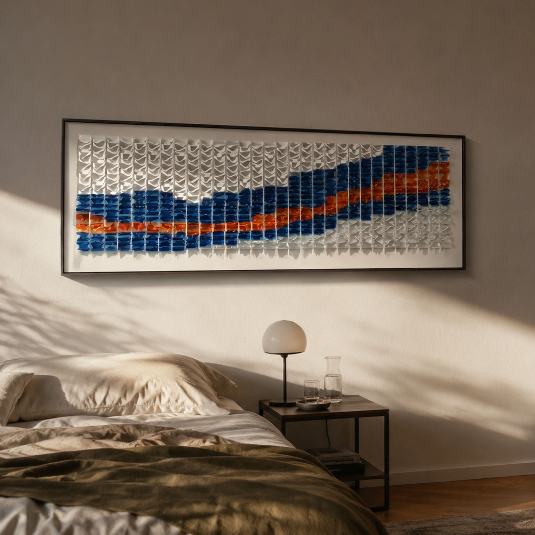 Waveform I Dual Motion Acrylic 3D Wall Art by Giant Sculptures in indigo, white, and orange, mounted above a bed with a bedside lamp in a sunlit bedroom.