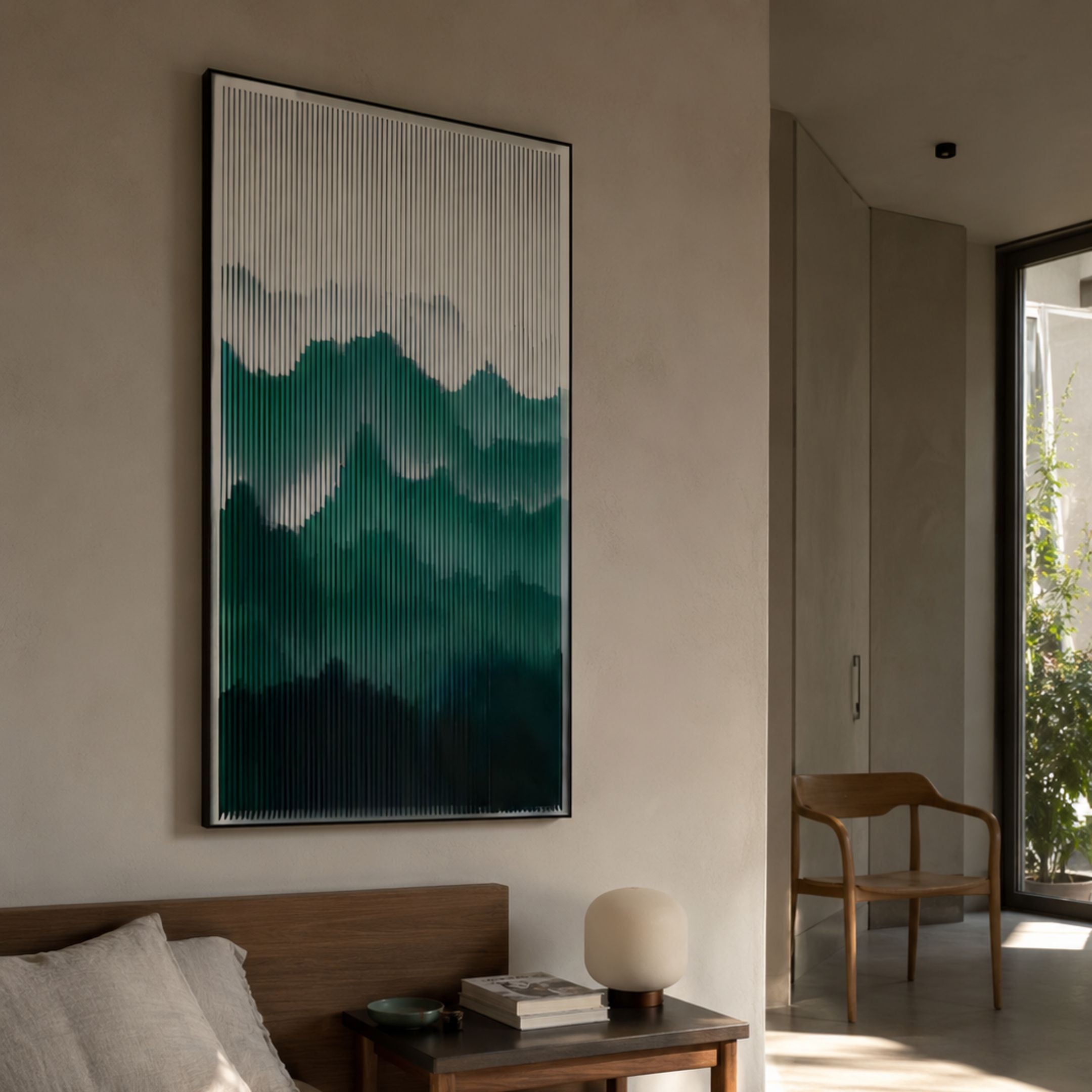 Mistline Emerald Mountain Scene Acrylic 3D Wall Art by Giant Sculptures mounted above a wooden bedside table in a sunlit minimalist bedroom with a wooden chair.