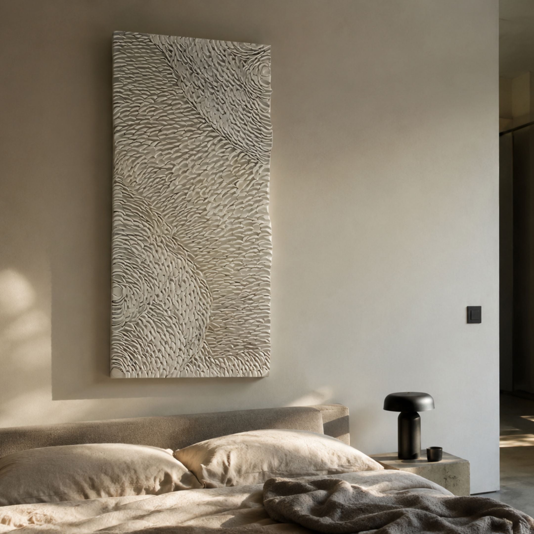 Vermira Ivory II Textured Leather 3D Metal Framed Wall Art mounted above a linen-dressed bed with a black mushroom lamp on a stone nightstand.