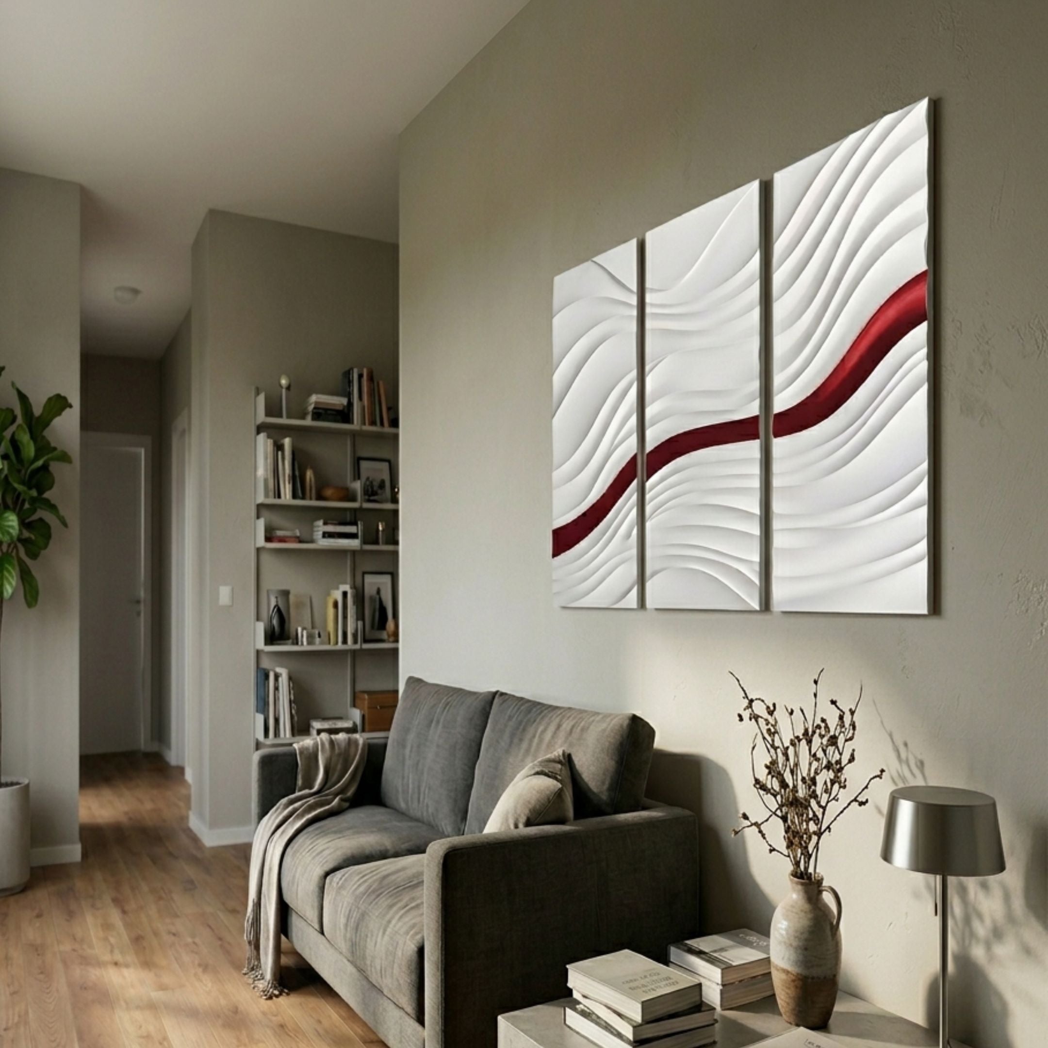 Evolva 3-Panel White & Red Wood Relief 3D Wall Art by Giant Sculptures displayed above a grey sofa in a neutral living room with bookshelf and floor lamp.