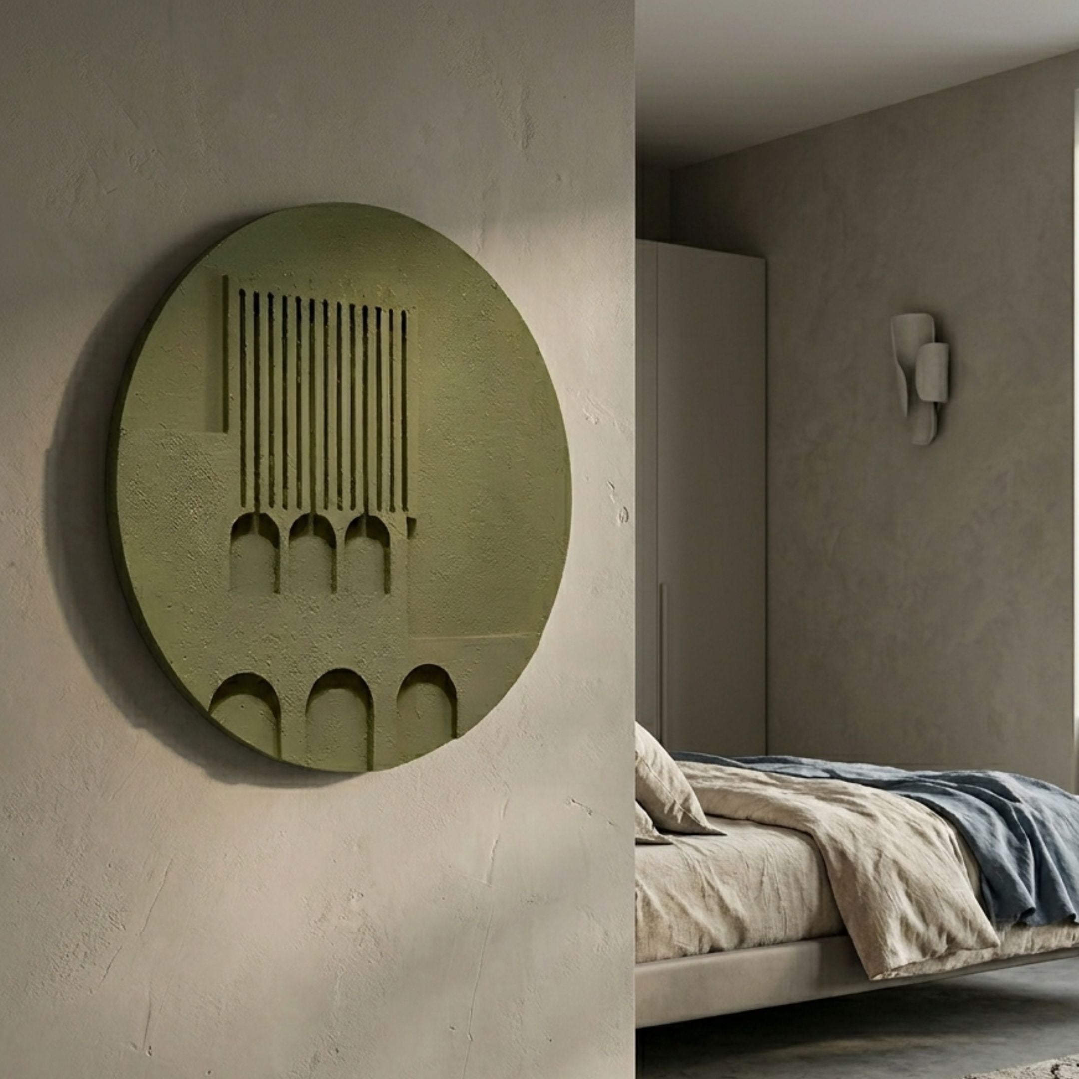 Arcuza Olive I Wood Carving Sandstone 3D Wall Art by Giant Sculptures mounted on a plaster wall beside a linen-dressed bed with a sconce in the bedroom.