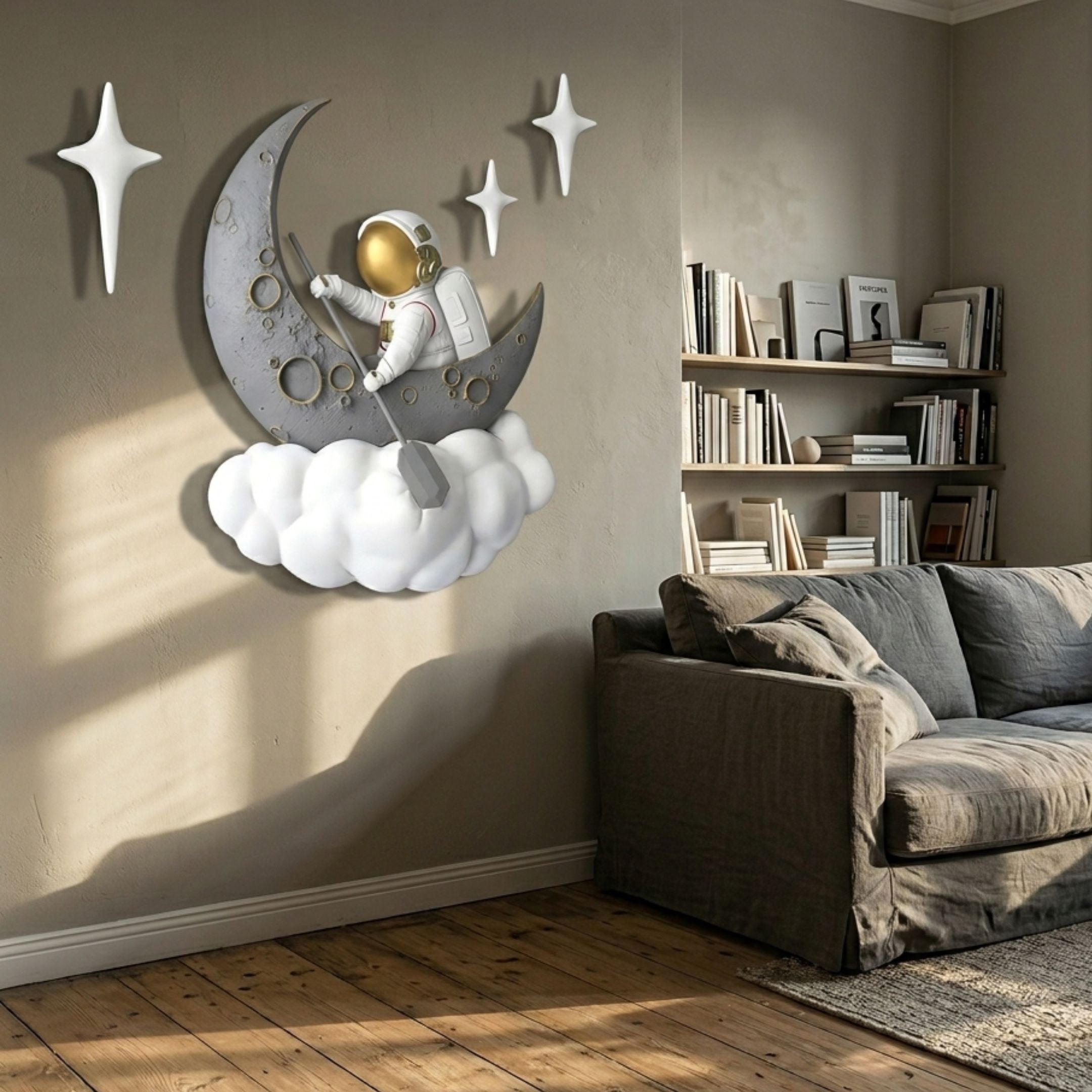 3D MoonSail Astronaut On Clouds Wall Art by Giant Sculptures mounted on a beige living room wall above a grey sofa, with white star accents beside the crescent moon scene.