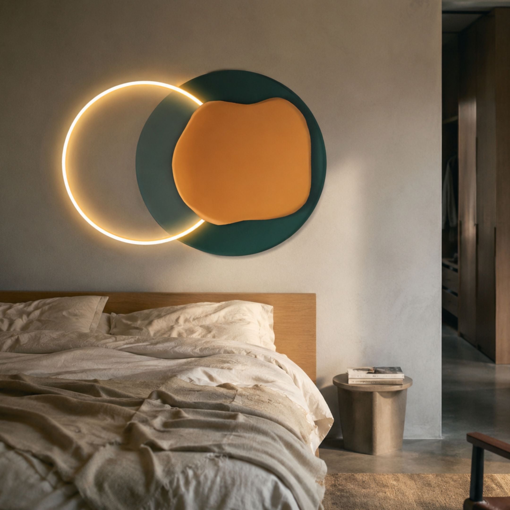 Arcadia Teal Ochre Leather 3D LED Wall Art by Giant Sculptures, illuminated circle paired with teal and ochre forms above an oak bed in a modern bedroom.
