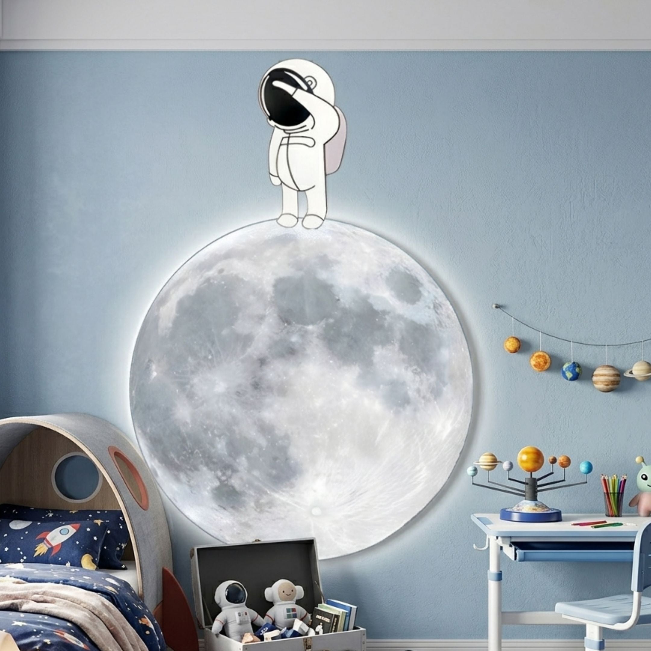Cosmos Astronaut Wonder UV Wood Carving LED Wall Art by Giant Sculptures shown above a space-themed kids bed, with the astronaut shading its visor atop a backlit full moon.