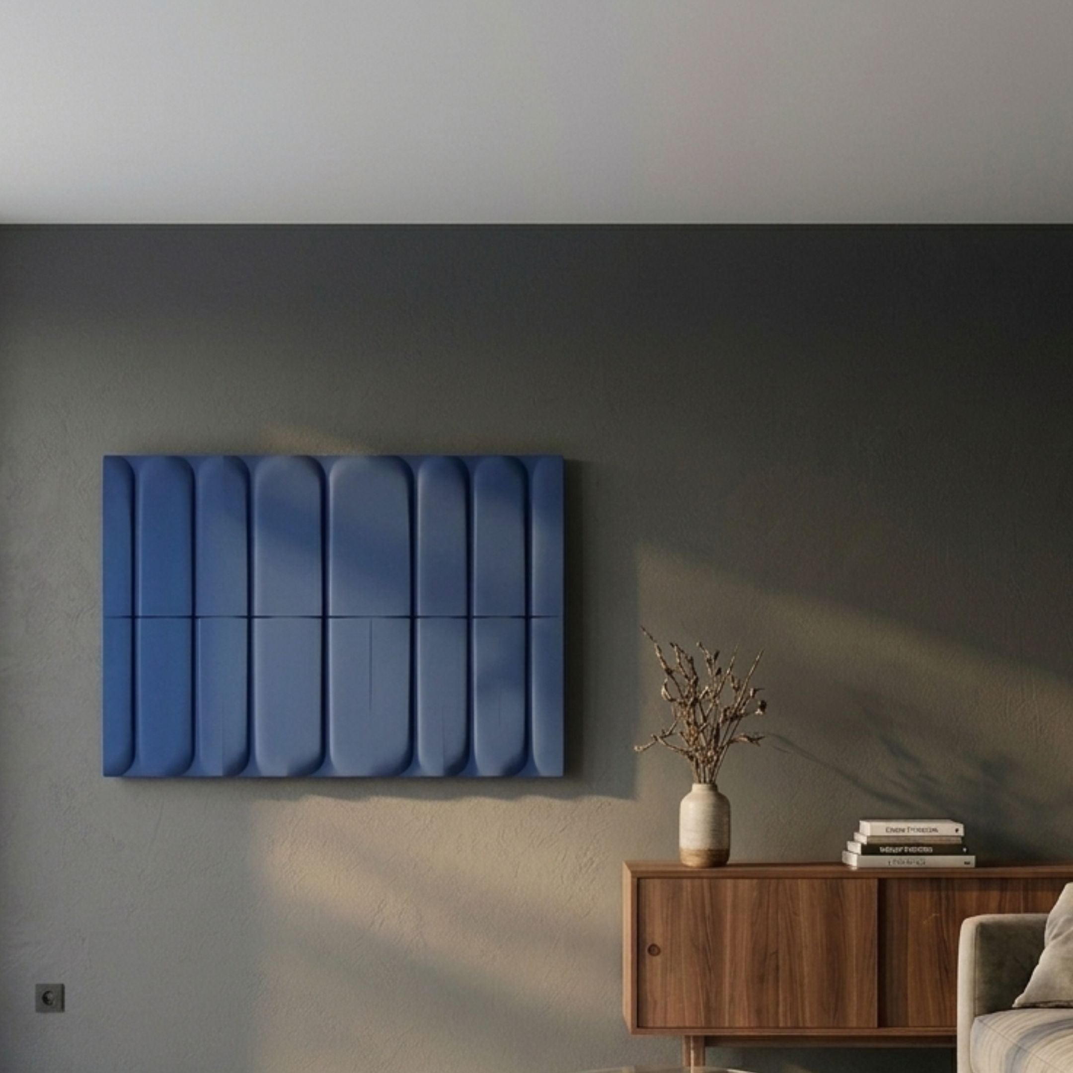 Vireus Midnight Blue Rectangular 3D Wood Relief Wall Panel by Giant Sculptures mounted on a grey living room wall above a walnut sideboard with a vase.