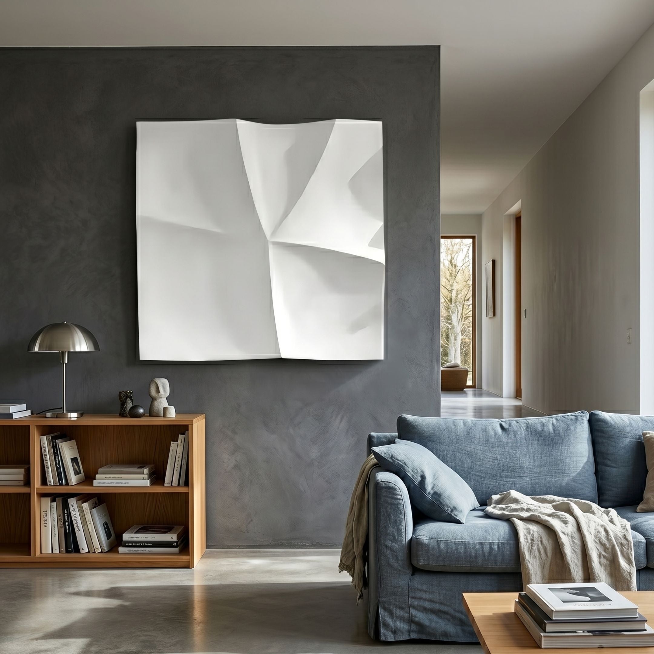 Tessara I White 3D Wood Relief Wall Art by Giant Sculptures displayed on a dark grey feature wall above a wooden bookcase beside a blue linen sofa.