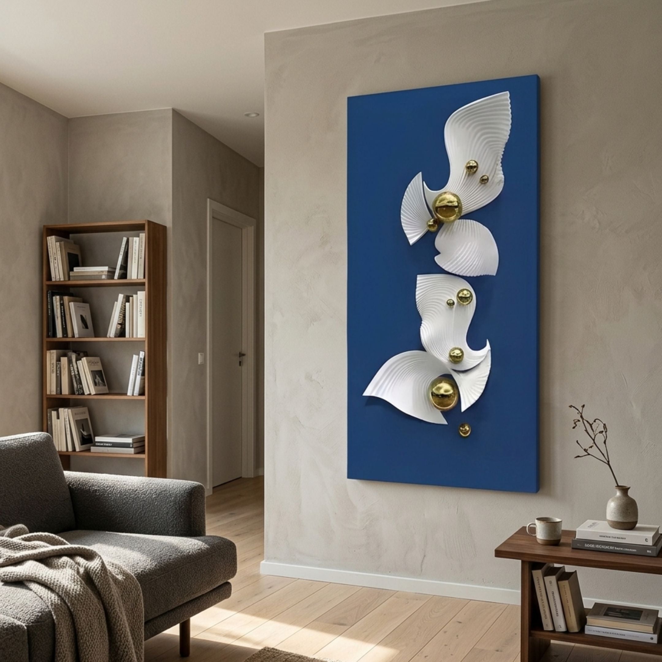 Aurelia Blue & White 3D Wood Wall Art With Metal Ball mounted in a modern living room beside a bookshelf, grey armchair, and wooden side table.