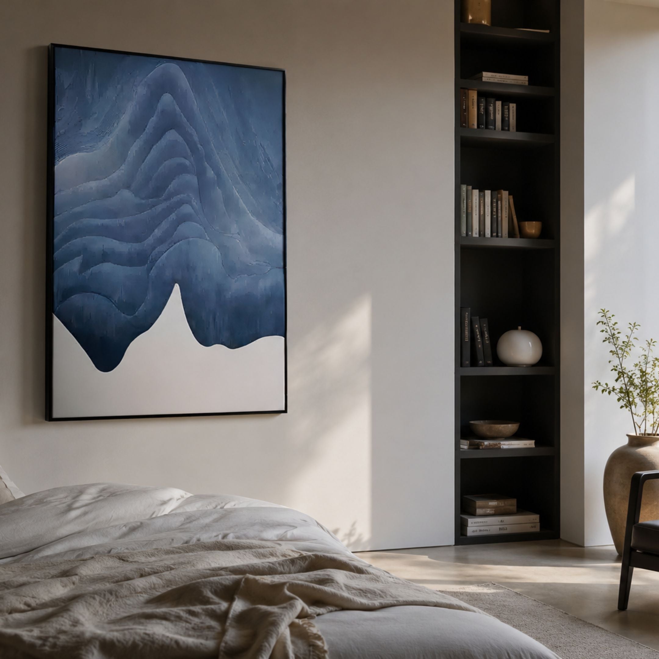 Celoria Azure Tide Wood Carving 3D Wall Art by Giant Sculptures, layered blue wave forms above a white base, hung in a minimalist bedroom beside a black bookshelf.