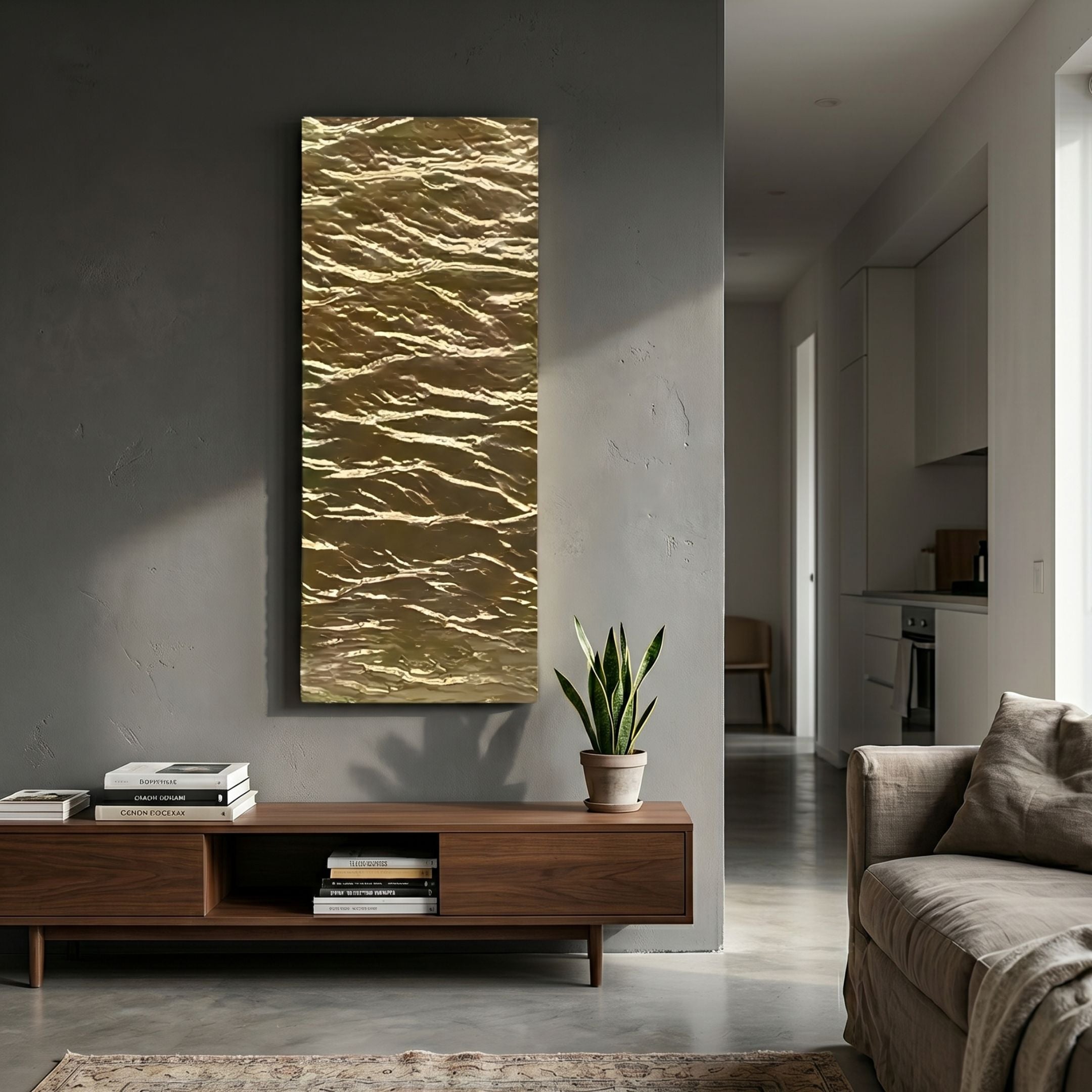 Illume Gold II Hand-Painted Wood Relief 3D Wall Art by Giant Sculptures, a tall crumpled gold panel on a grey wall above a walnut console with snake plant.
