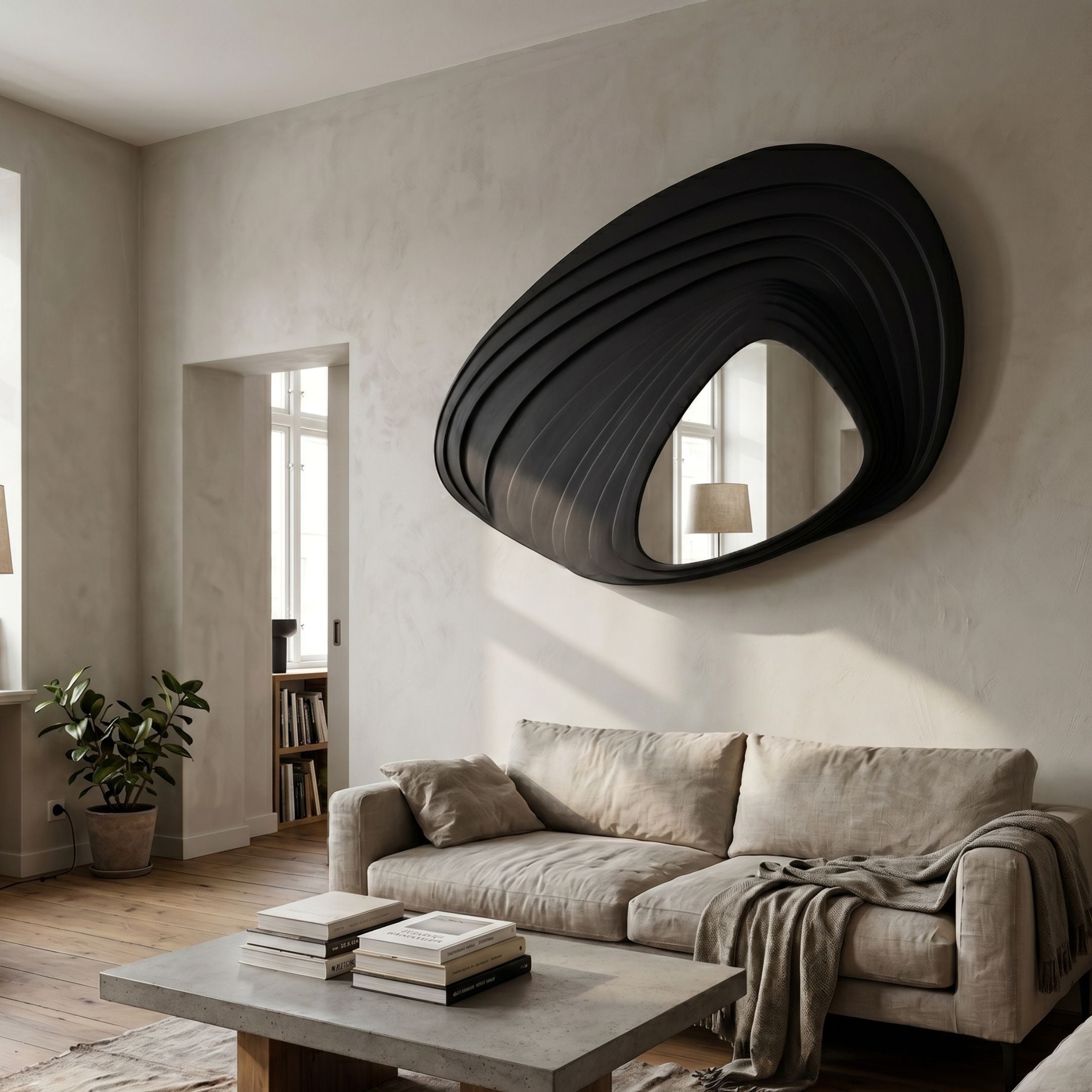 Reflecta Black Wood Carving Mirror 3D Wall Art by Giant Sculptures displayed above a beige linen sofa in a neutral living room with concrete coffee table.