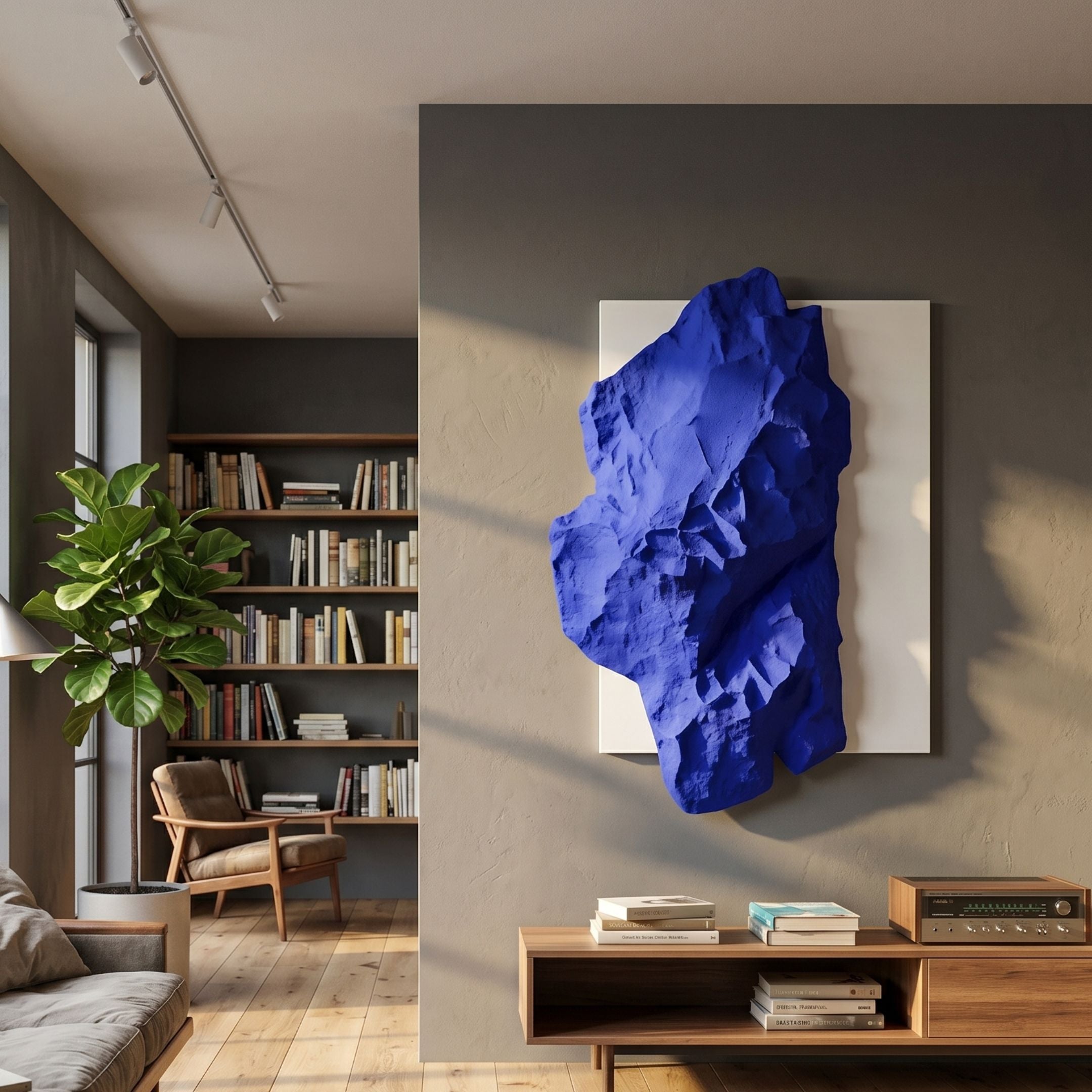 Veritas White & Sapphire Blue Wood Relief 3D Wall Art mounted on a beige living room wall above a wooden console, beside a bookshelf and fiddle-leaf fig.