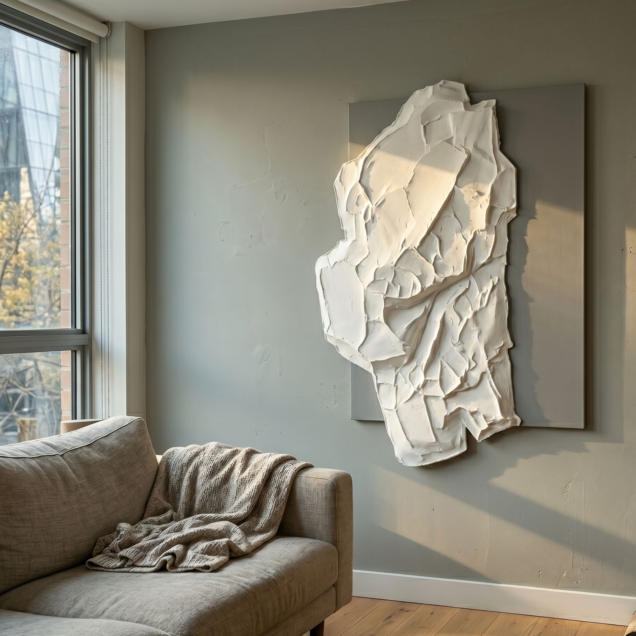 Veritas White & Grey Abstract Wood Relief 3D Wall Art by Giant Sculptures mounted on a grey living room wall above a linen sofa near a sunlit window.