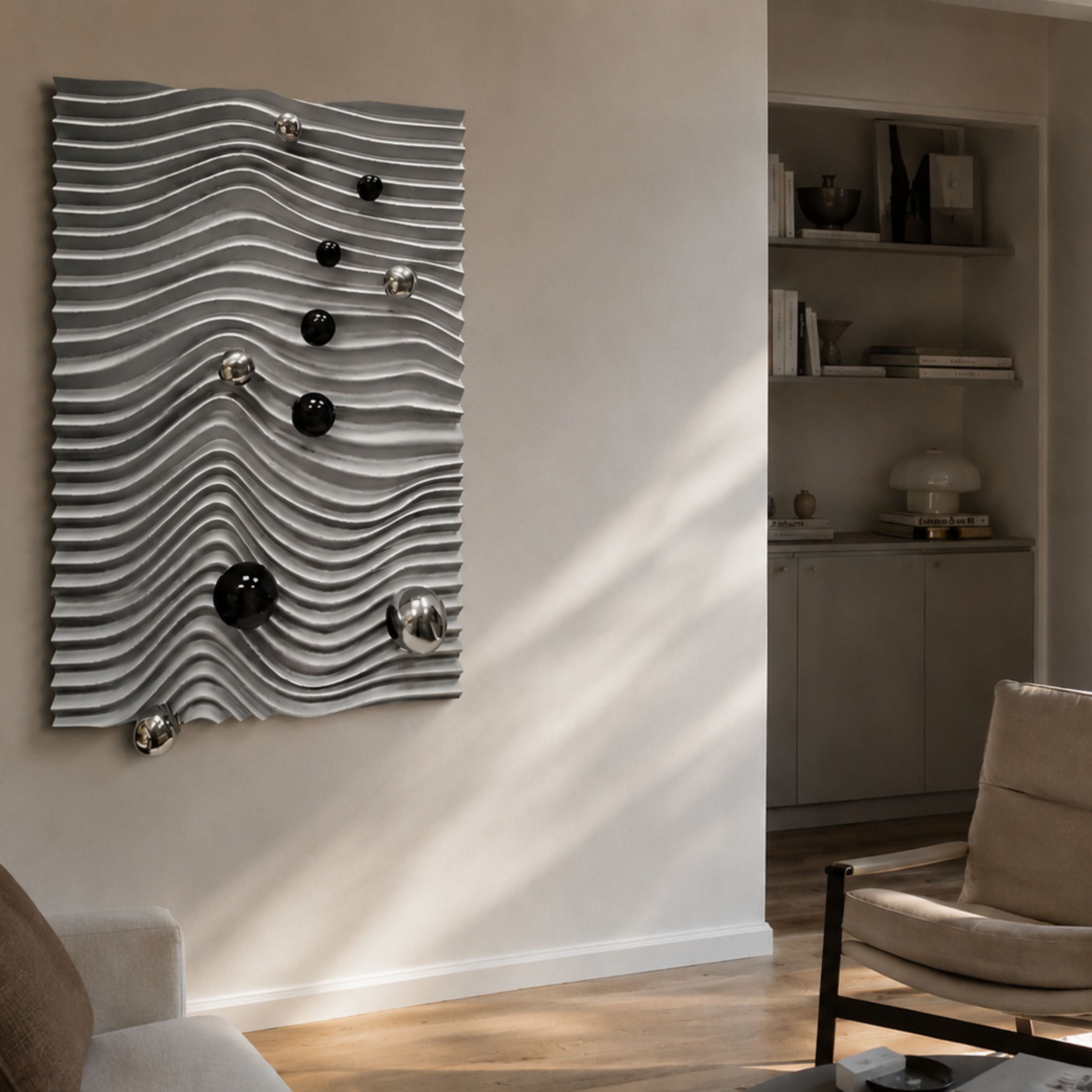 Calidora Wave Sculpted Textured 3D Relief Wall Art by Giant Sculptures, silver wavy ridges with black and chrome spheres, mounted in a sunlit living room.