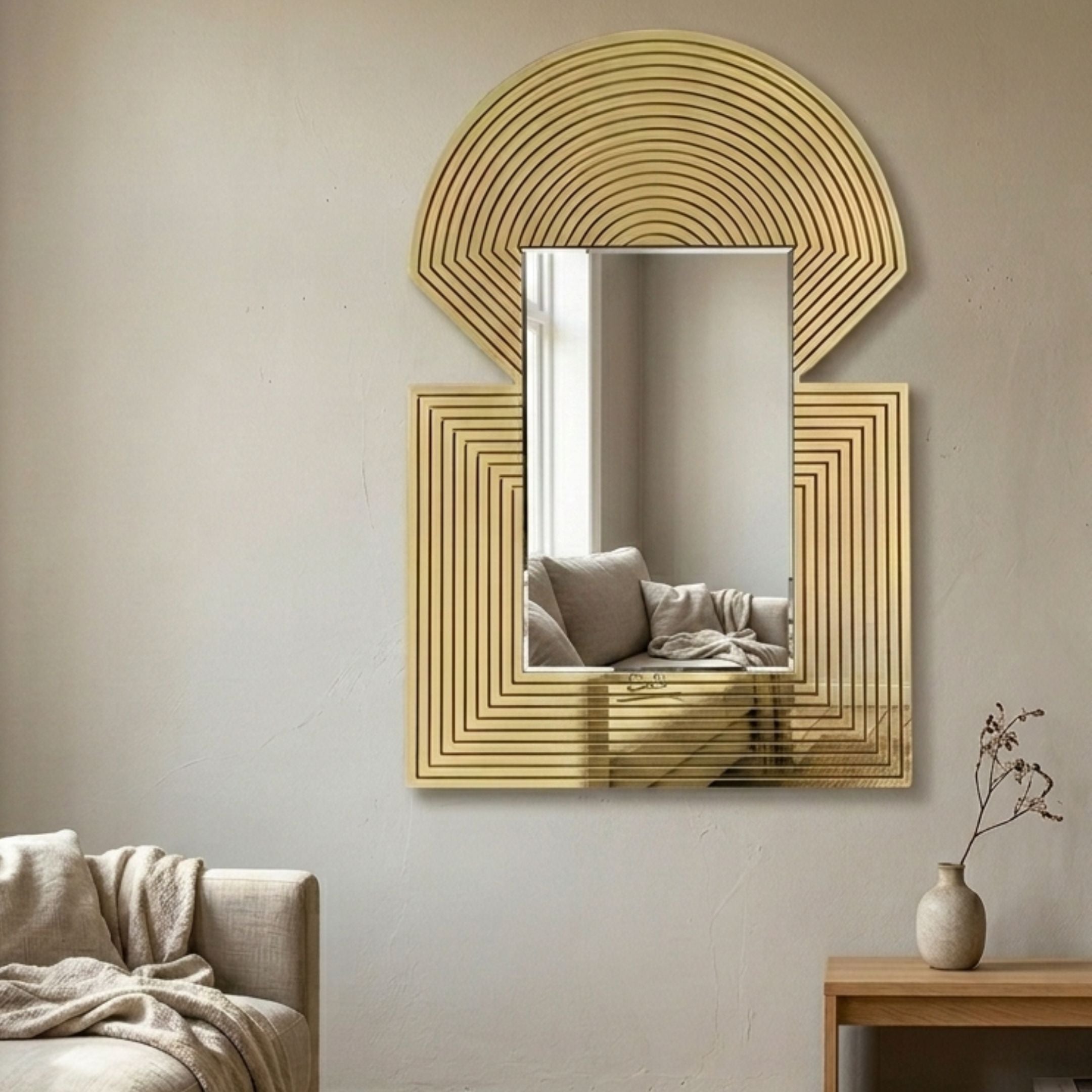 Aurellis Gold Arch & Square Geometric Mirror Frame Wall Art mounted above a beige armchair, with concentric gold linework framing a rectangular mirror.