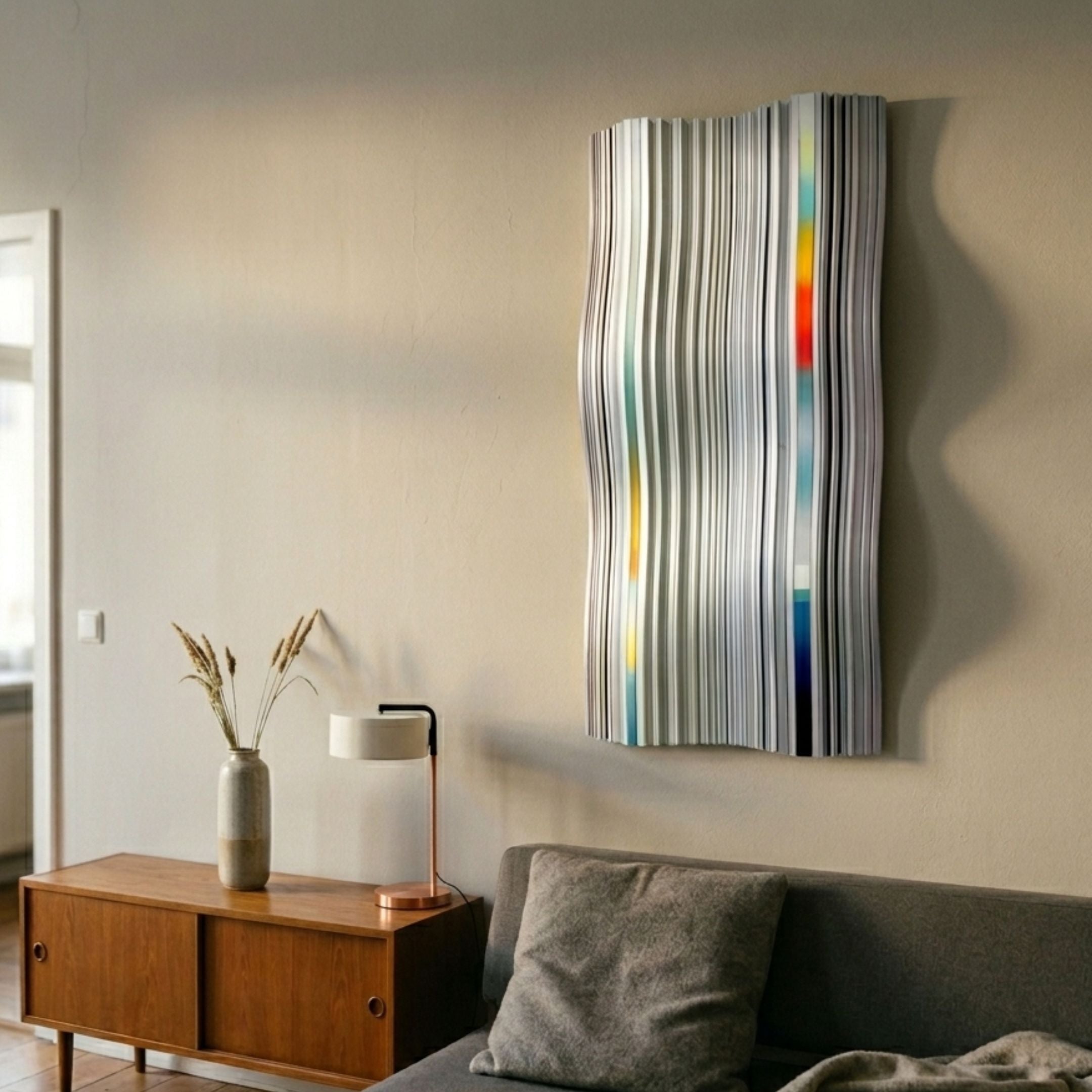 Illumina Chrome Colourful Vertical Wooden Hand-Painted 3D Wall Art with wavy grey, white, yellow, red and blue stripes above a mid-century sideboard.