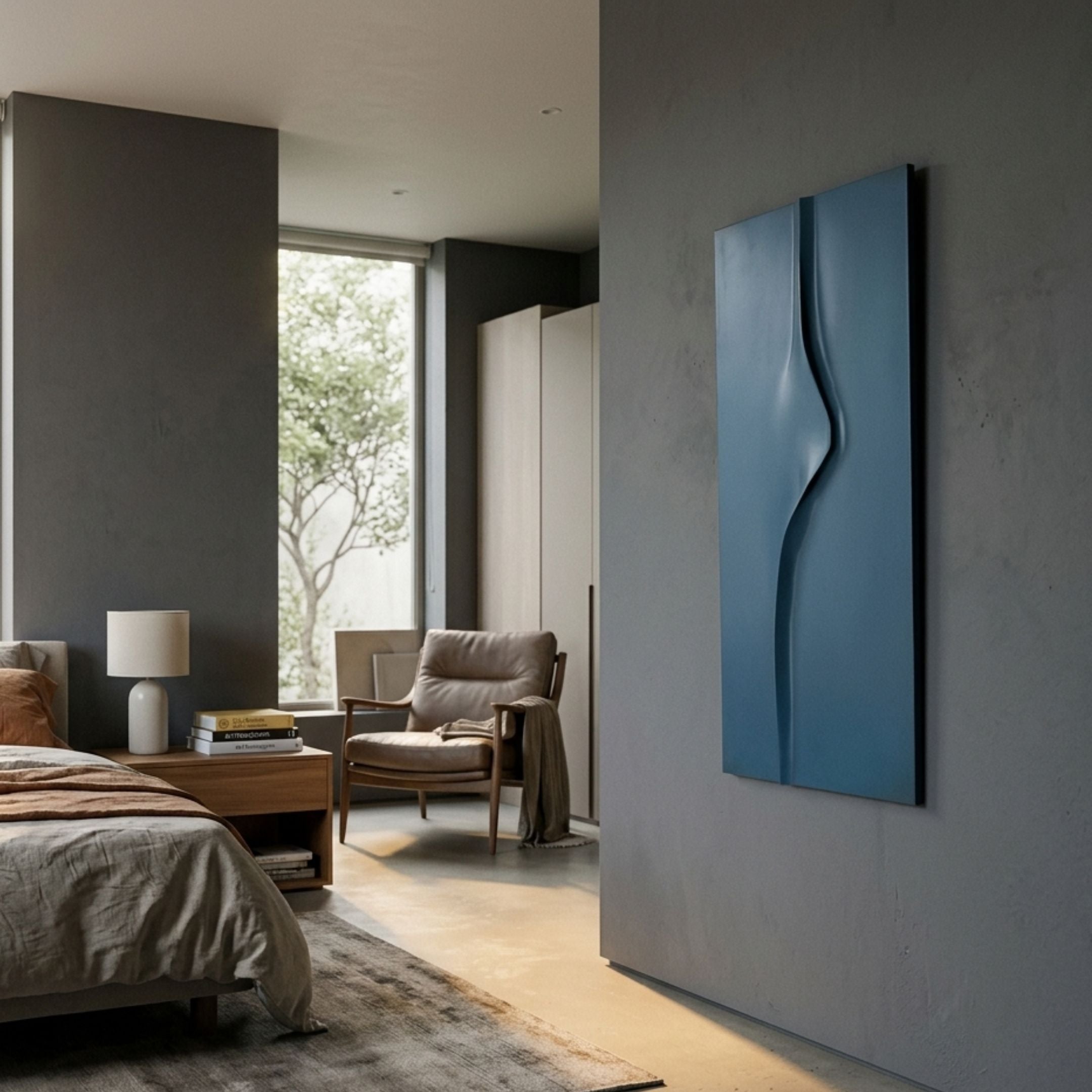 Velar Vertical Blue Wood Carving 3D Wall Art by Giant Sculptures mounted on a grey bedroom wall beside a leather armchair, bed, and window.