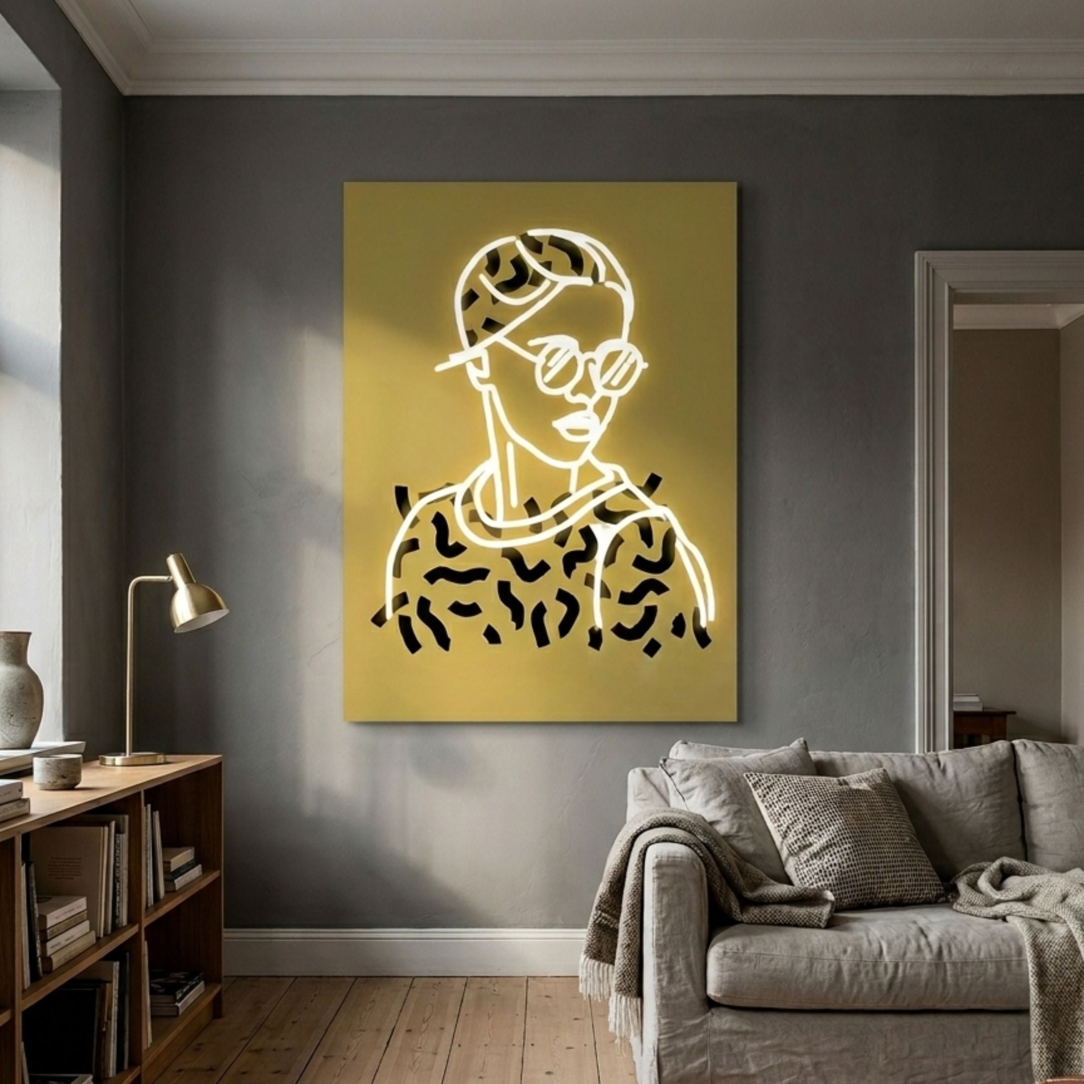 Orison Retro Pop Crystal Porcelain 3D LED Wall Art by Giant Sculptures, glowing neon figure with sunglasses on yellow panel above a sofa in a grey living room.