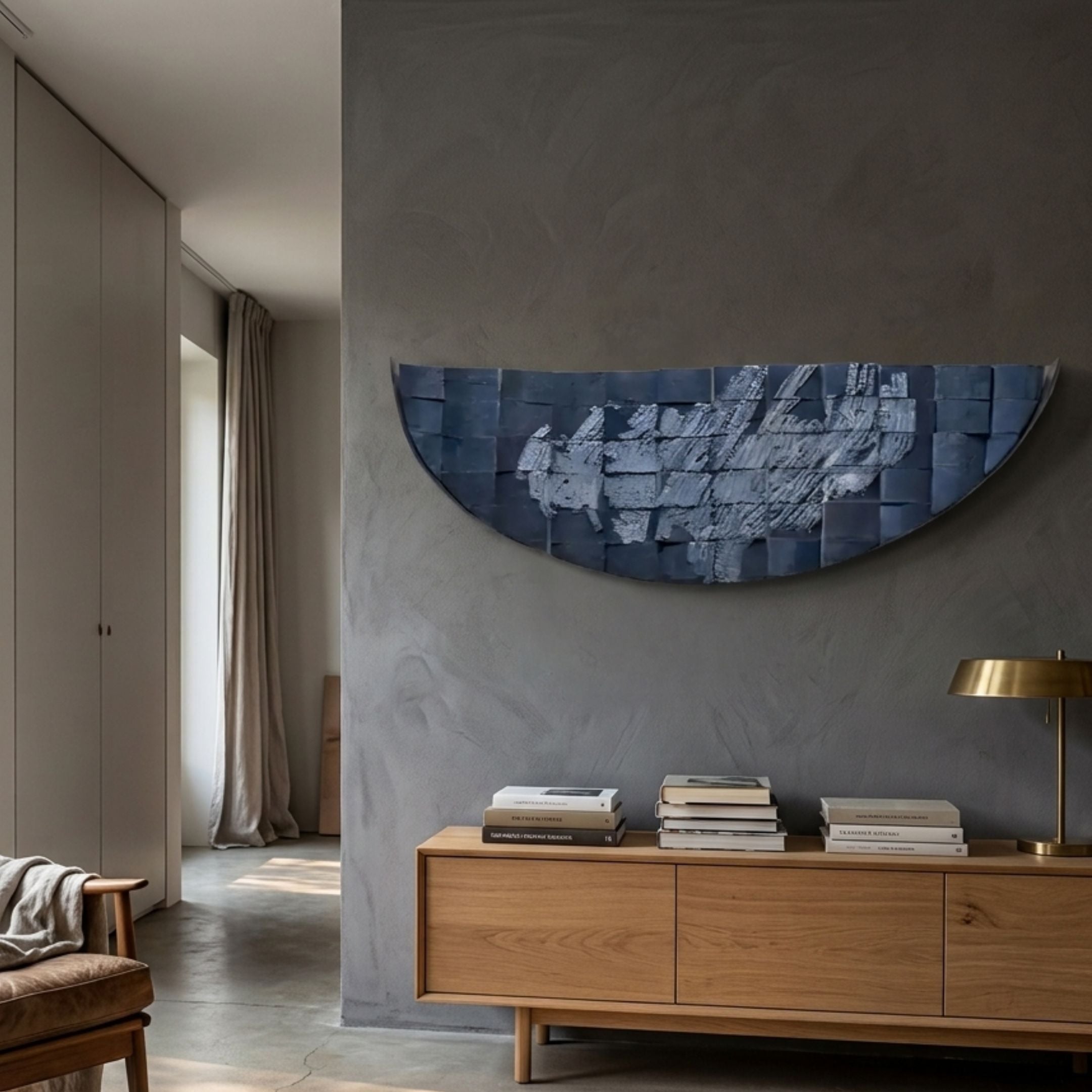 Arcana Midnight Blue Textured Mosaic Half-Moon 3D Wall Art mounted on a grey wall above an oak sideboard with stacked books and a brass lamp.