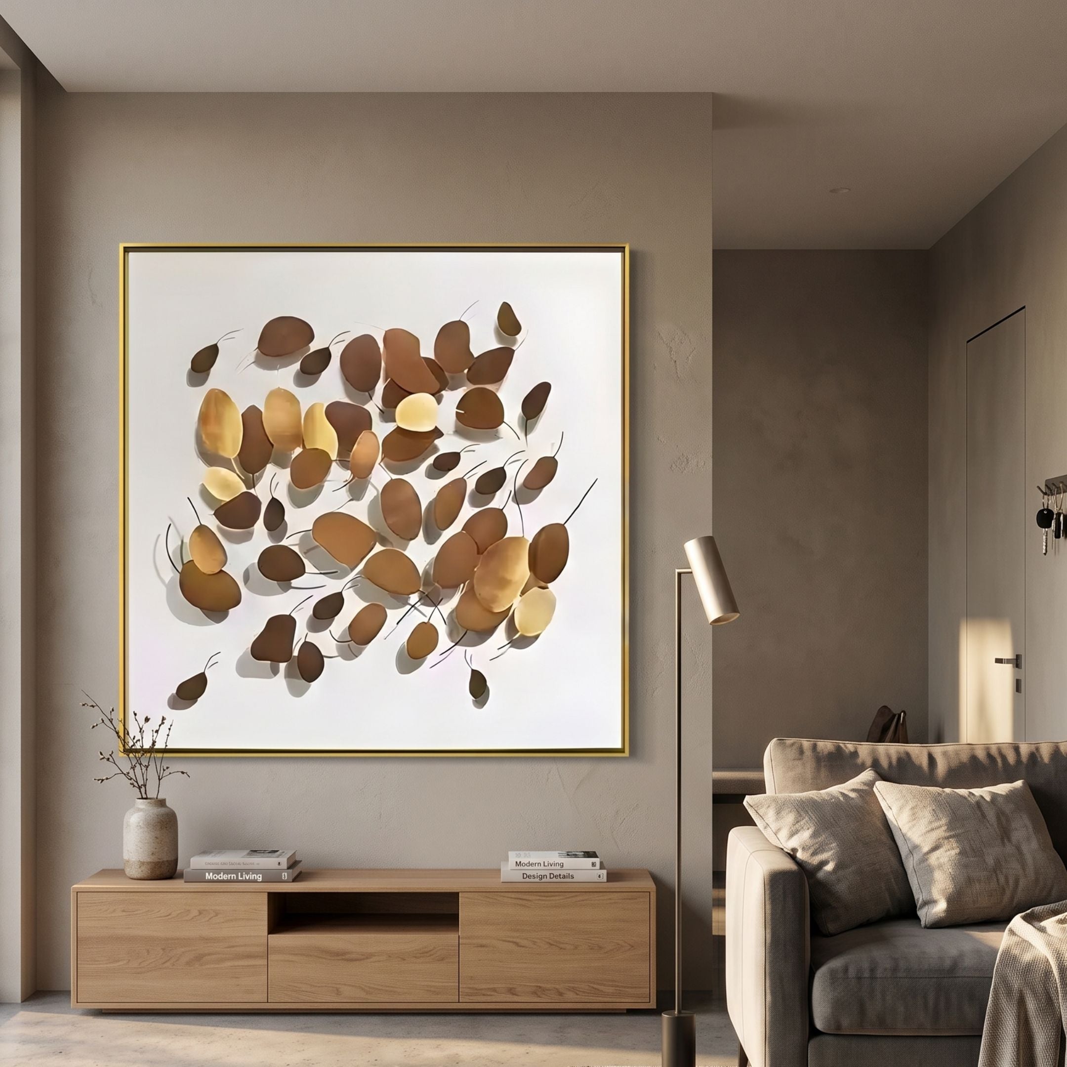 Brassica Gold Leaf Metal Square Wall Art by Giant Sculptures displayed above a wooden console with vase and books in a neutral modern living room.