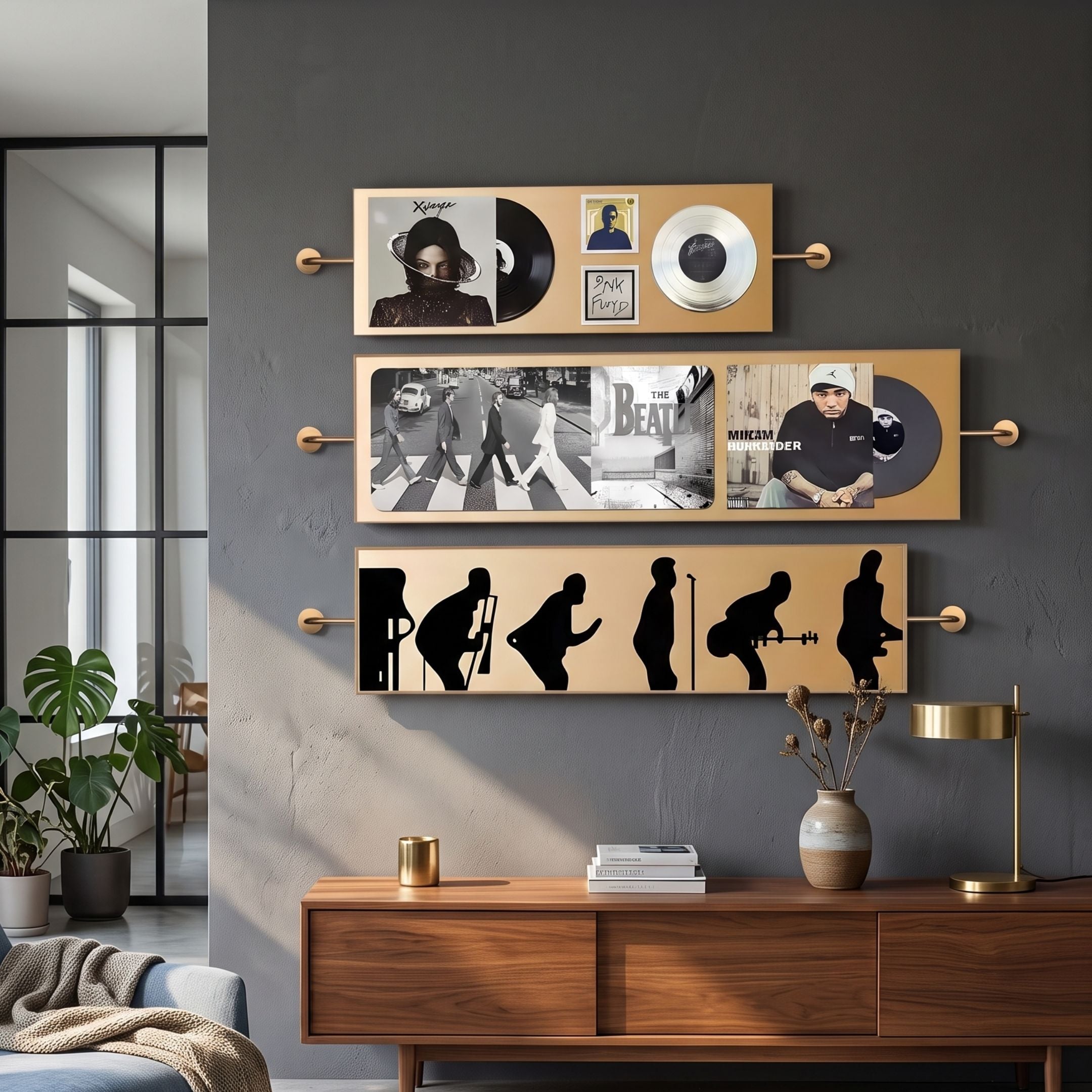 Resonance Multi-Panel Record & Silhouette Wall Art by Giant Sculptures, three gold-framed panels with vinyl covers and black silhouettes on a grey living room wall.