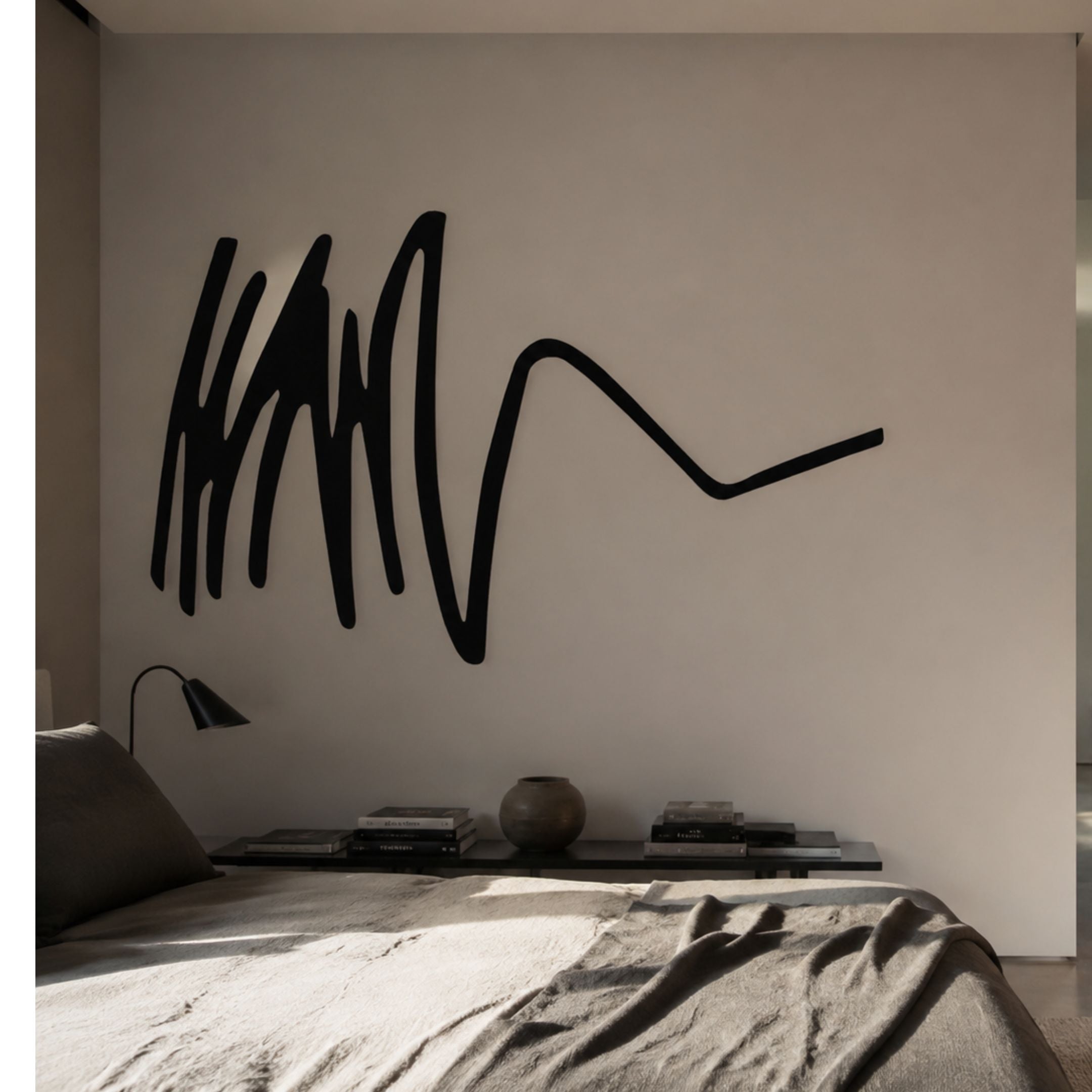 Oscura Dynamic Flow Black Abstract Metal Wall Art by Giant Sculptures mounted above a bedroom console with books, vase, and lamp beside a linen-dressed bed.