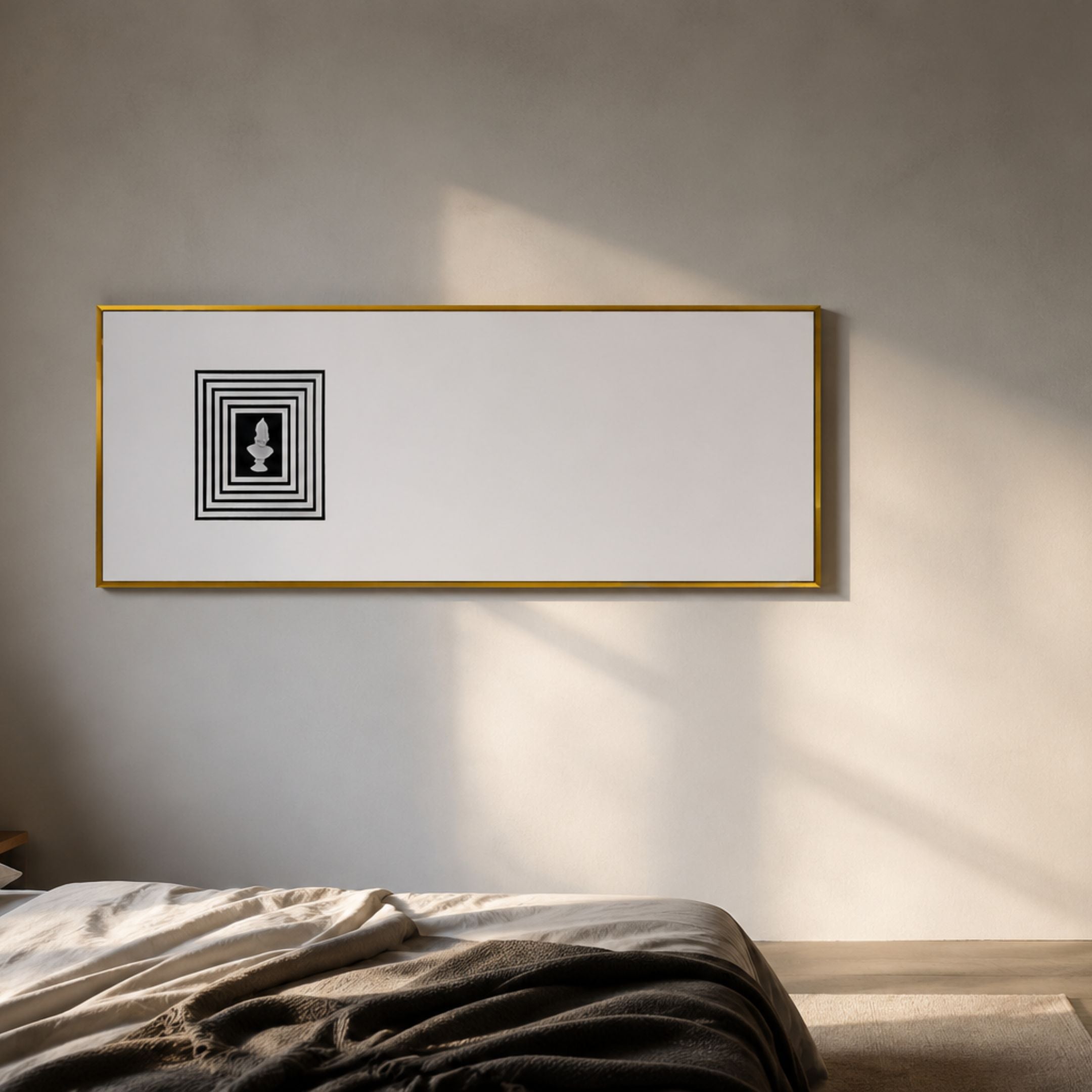 Lustreline Black & White Left Plaster Statue Cardboard Wall Art in a slim gold frame, displayed above a bed with linen bedding in a sunlit bedroom.