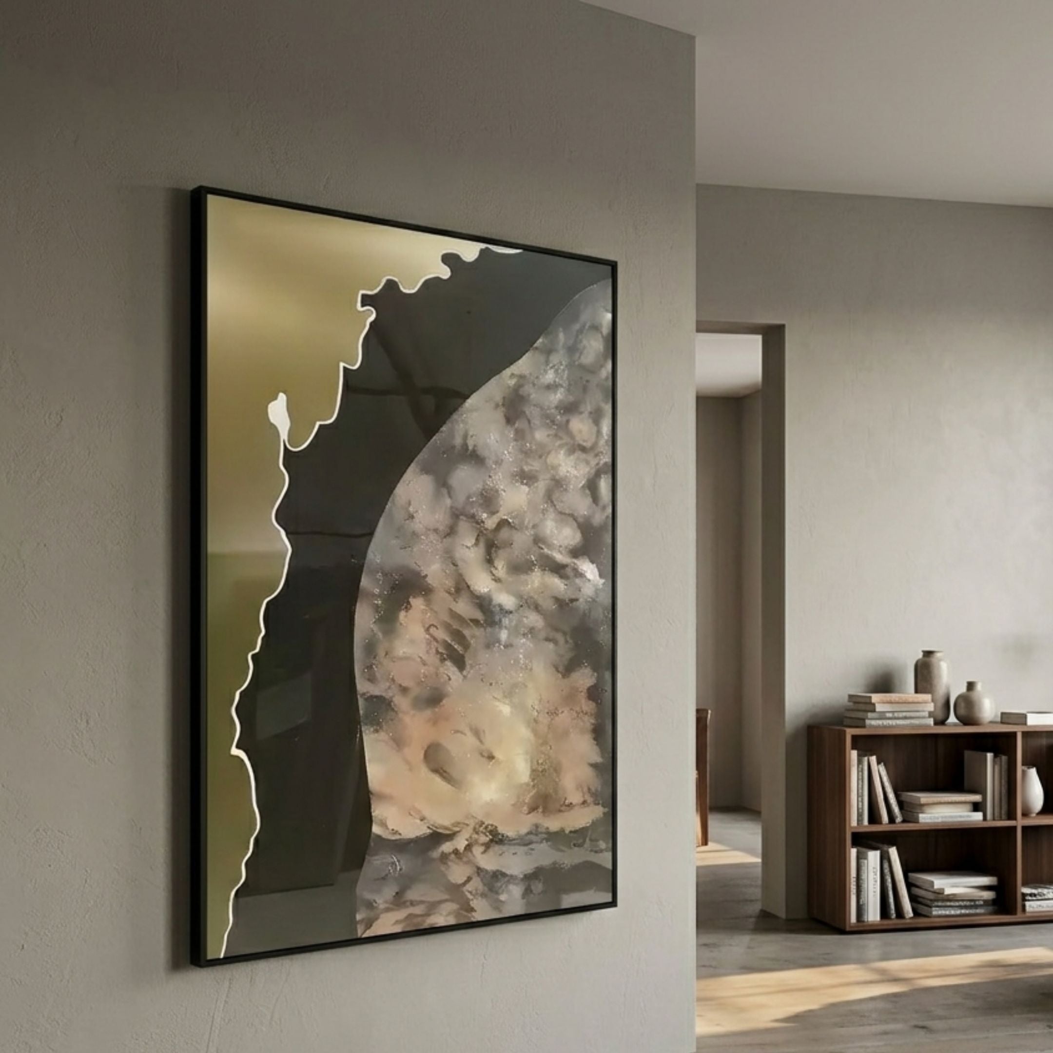 Astrid Gold Edge Earthy Abstract Wall Art by Giant Sculptures, framed in black with cream, grey, and gold textured composition, hung in a neutral living space beside a walnut bookshelf.