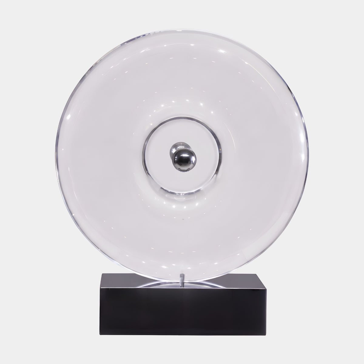 Clear Machined Dish Disc & Steel Sphere Resin Sculpture, 65cm, with a polished steel sphere at its centre, on a black rectangular base against a plain white background.