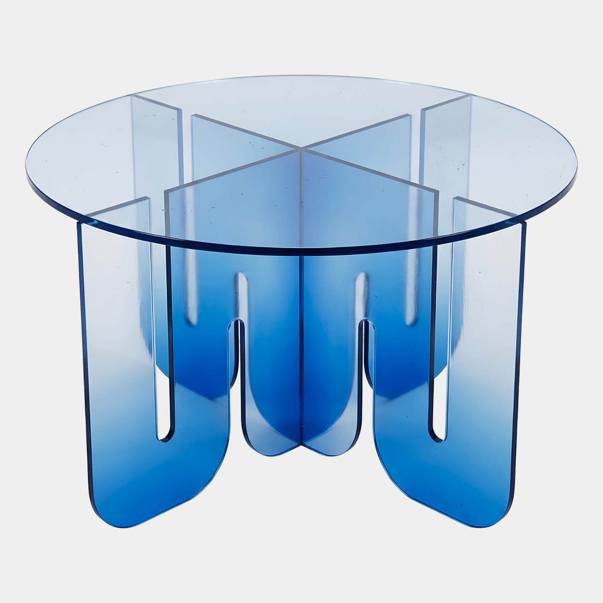Blue Graded Round Acrylic Low Table on Arched Panels - 80cm, round acrylic top over crossed arched panel legs, color fading from blue to clear, on a plain white background.