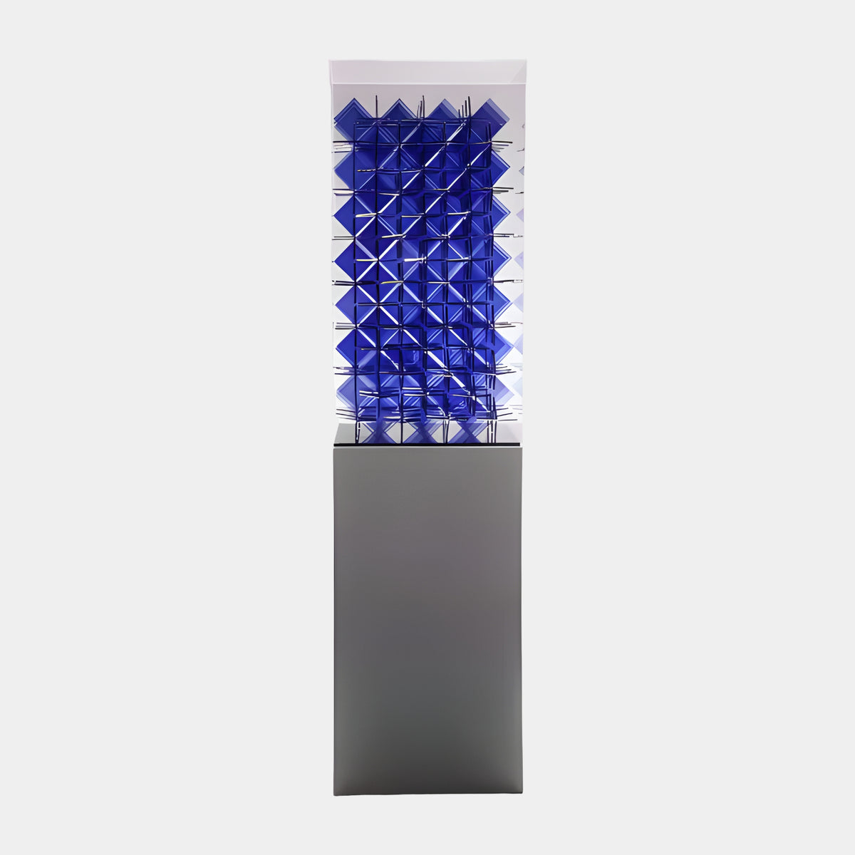 Blue Faceted Lattice Acrylic Sculpture on Marble - 170cm, a grid of faceted blue pyramid forms in a clear acrylic case on a grey marble plinth, set against a plain light background.