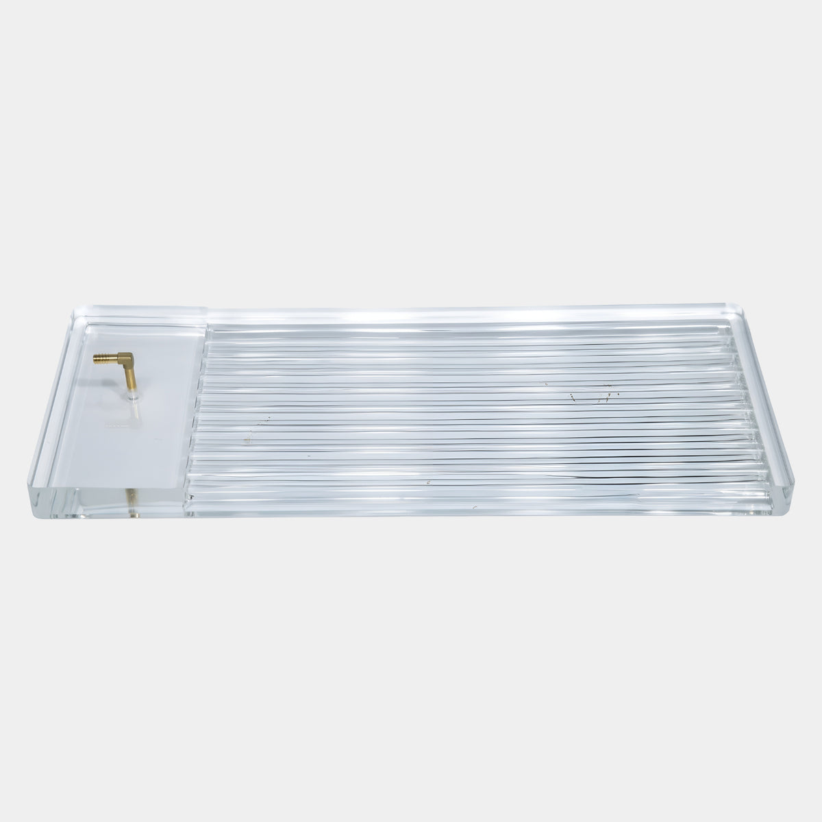 Clear Ribbed Acrylic Serving Tray with Brass Fitting (70cm) by Giant Sculptures, ribbed channel floor and plain sunken end with brass accent, on a plain white background.
