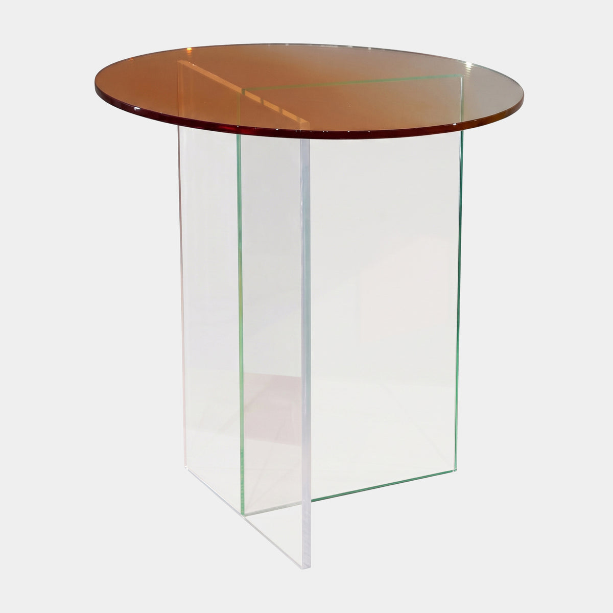 Amber Glass Side Table on Clear Crossed Panels, 55cm, round amber-tinted glass top over clear acrylic cross-base, shown on a plain white background.