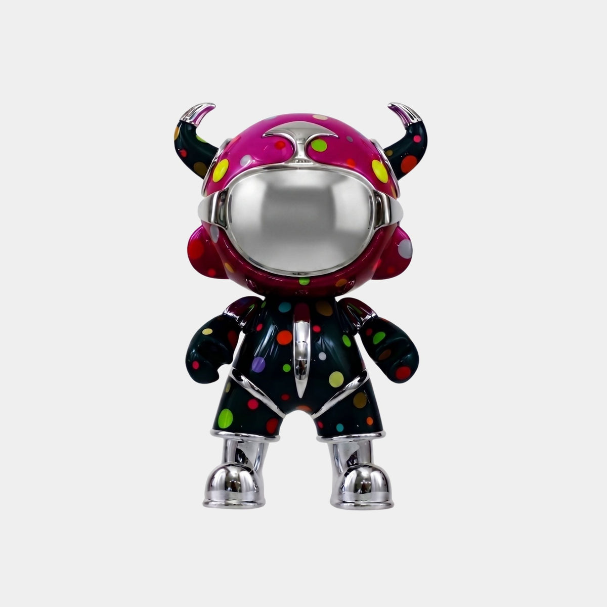 The Giant Sculptures Midnight Confetti Suit Astro Devil Figure (48cm) features a chrome, reflective face, black polka-dot outfit, and pink horned helmet—a striking contemporary piece ideal for bold pop-art decor.