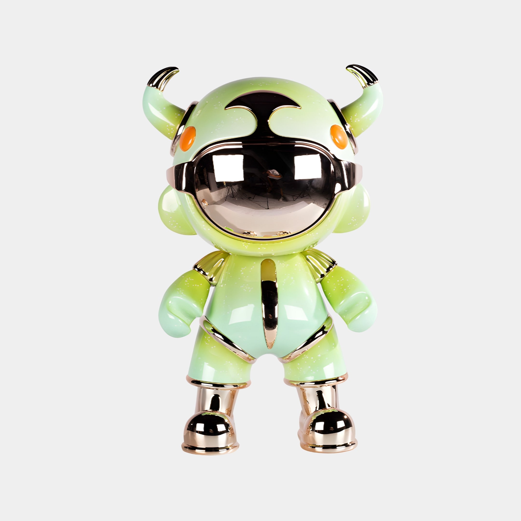 The Mint Green Suit Astro Devil Sculpture (80cm) by Giant Sculptures is a shiny green and silver humanoid figure with a mirrored chrome visor, orange eyes, and two horn-like structures, set against a plain white background.