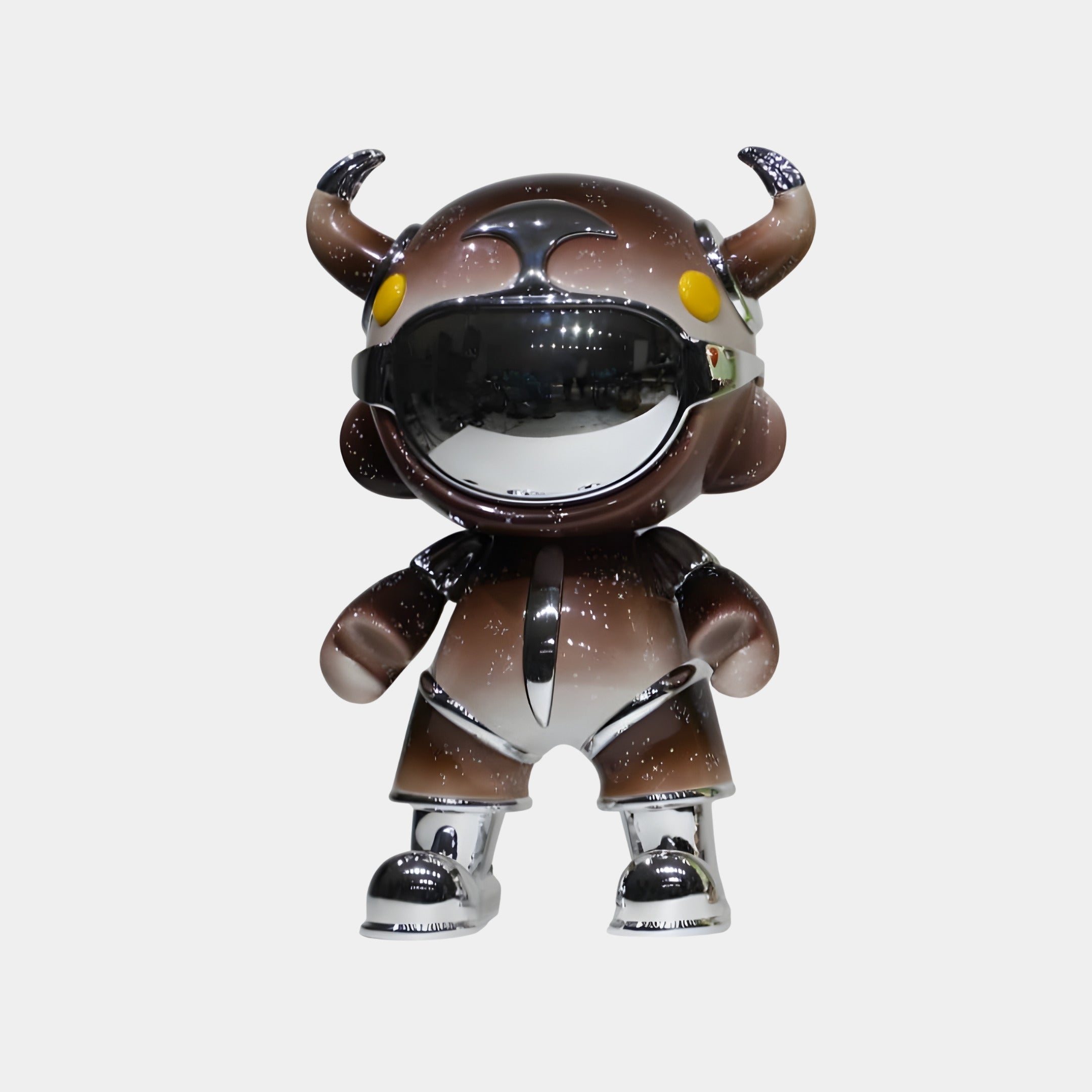 The Giant Sculptures Deep Brown Suit Astro Devil Sculpture (80cm) features a horned helmet, yellow circular eyes, and a reflective visor with contemporary metallic finishes, standing upright on a plain white background.