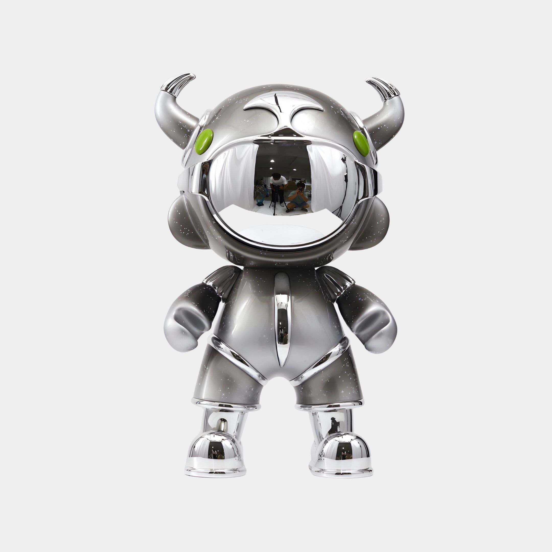 The Giant Sculptures Dark Chrome Suit Astro Devil Sculpture – 80cm features a shiny, chrome cartoon figure with horns, green eyes, and a mirrored visor for a bold, futuristic look.