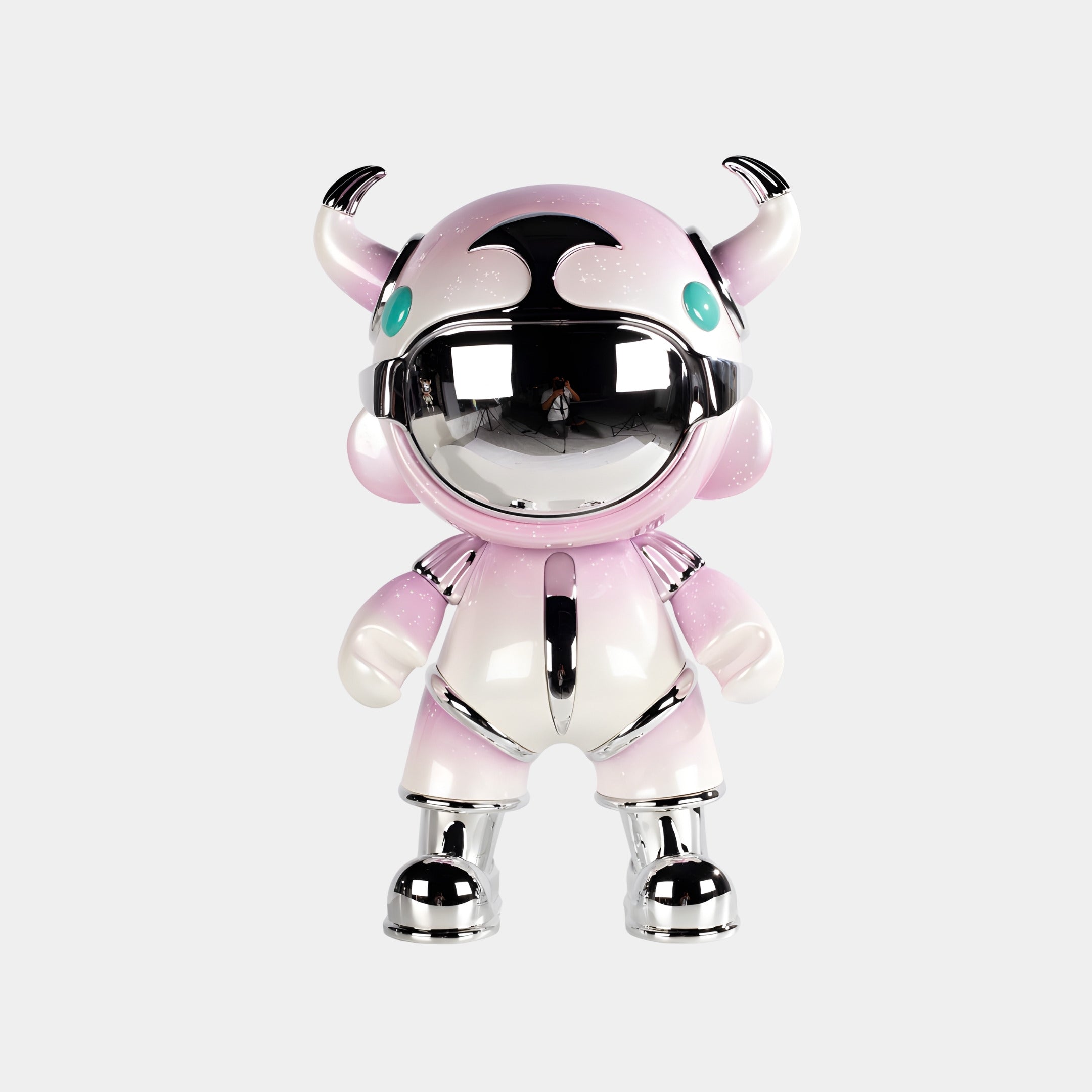 The Blush Pink Suit Astro Devil Sculpture - 80cm by Giant Sculptures features a chrome faceplate, silver hands and feet, small horns, teal eyes, and stands upright on a plain white background—a bold contemporary decor piece.