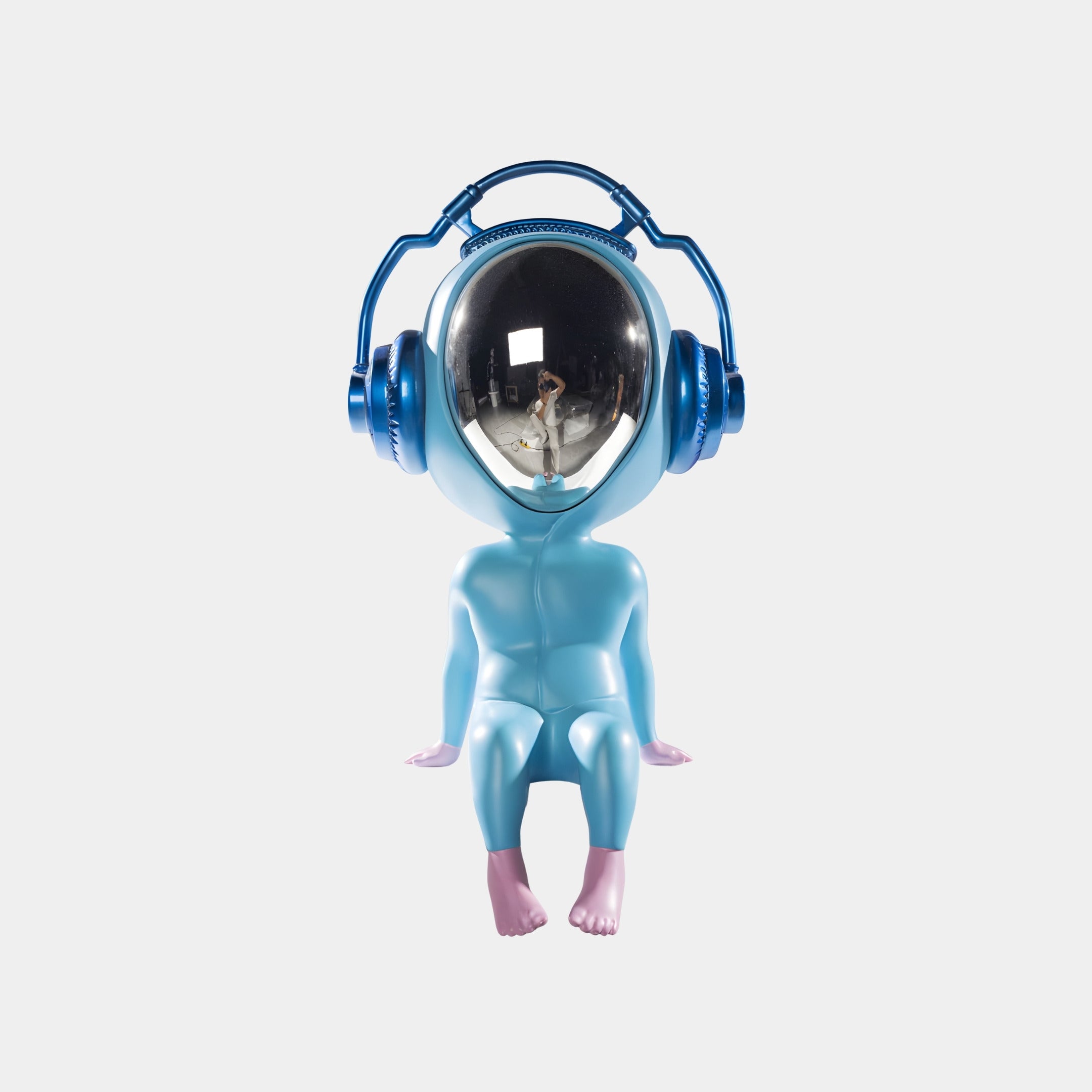 The Sky Blue Alien Beats Figure - 55cm by Giant Sculptures features a stylized alien with pink hands and feet, large headphones, and a reflective face—an eye-catching modern sculpture set against a white background.