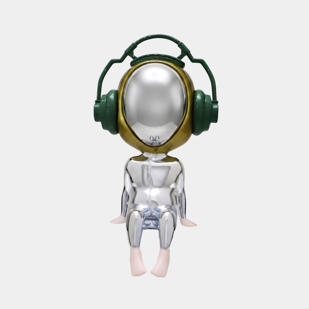 A shiny, metallic humanoid with a round reflective head, oversized green headphones, and bare feet sits with hands on its knees—the 55cm Mirror Chrome Alien Beats Figure by Giant Sculptures for sci-fi design lovers.
