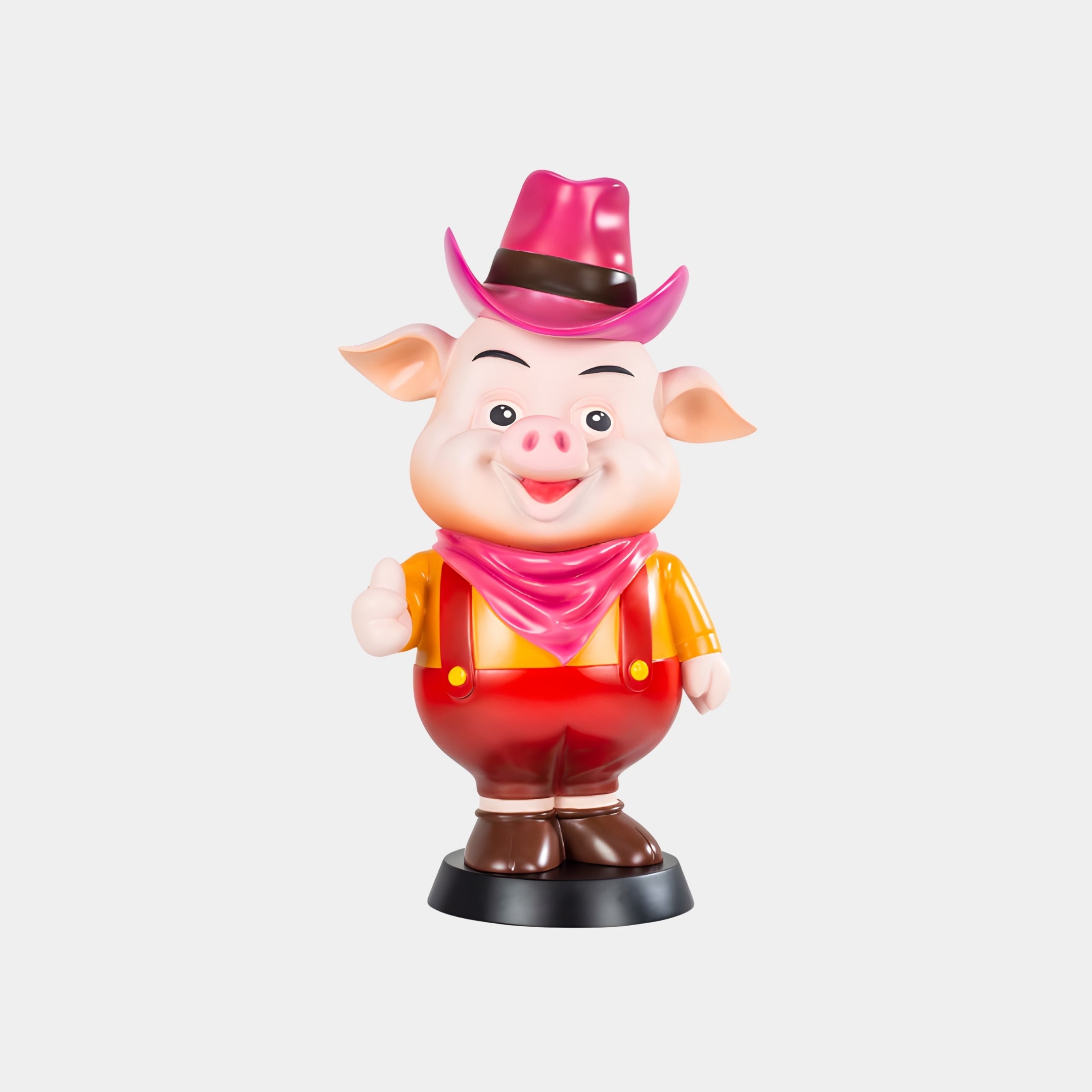 The Pink Hat Snortle Sculpture - 69cm by Giant Sculptures depicts a cheerful cartoon pig in a pink cowboy hat, red overalls, yellow shirt, and pink bandana, standing with one arm raised against a white background.