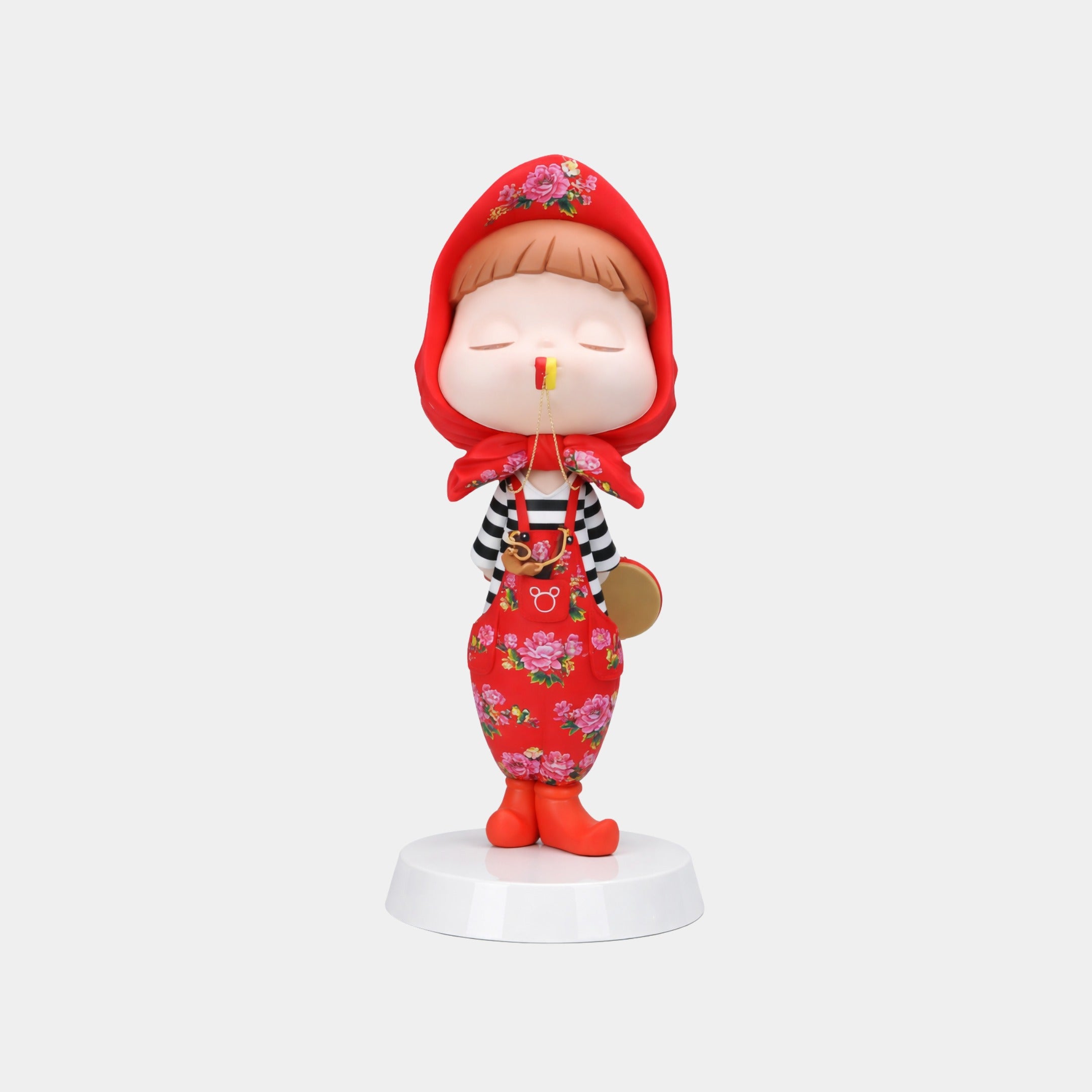 The Blossom Red Puffelle Sculpture - 68cm by Giant Sculptures shows a child with closed eyes in a red floral hood and overalls, standing on a white floral base with a butterfly on its nose—perfect as decorative art.